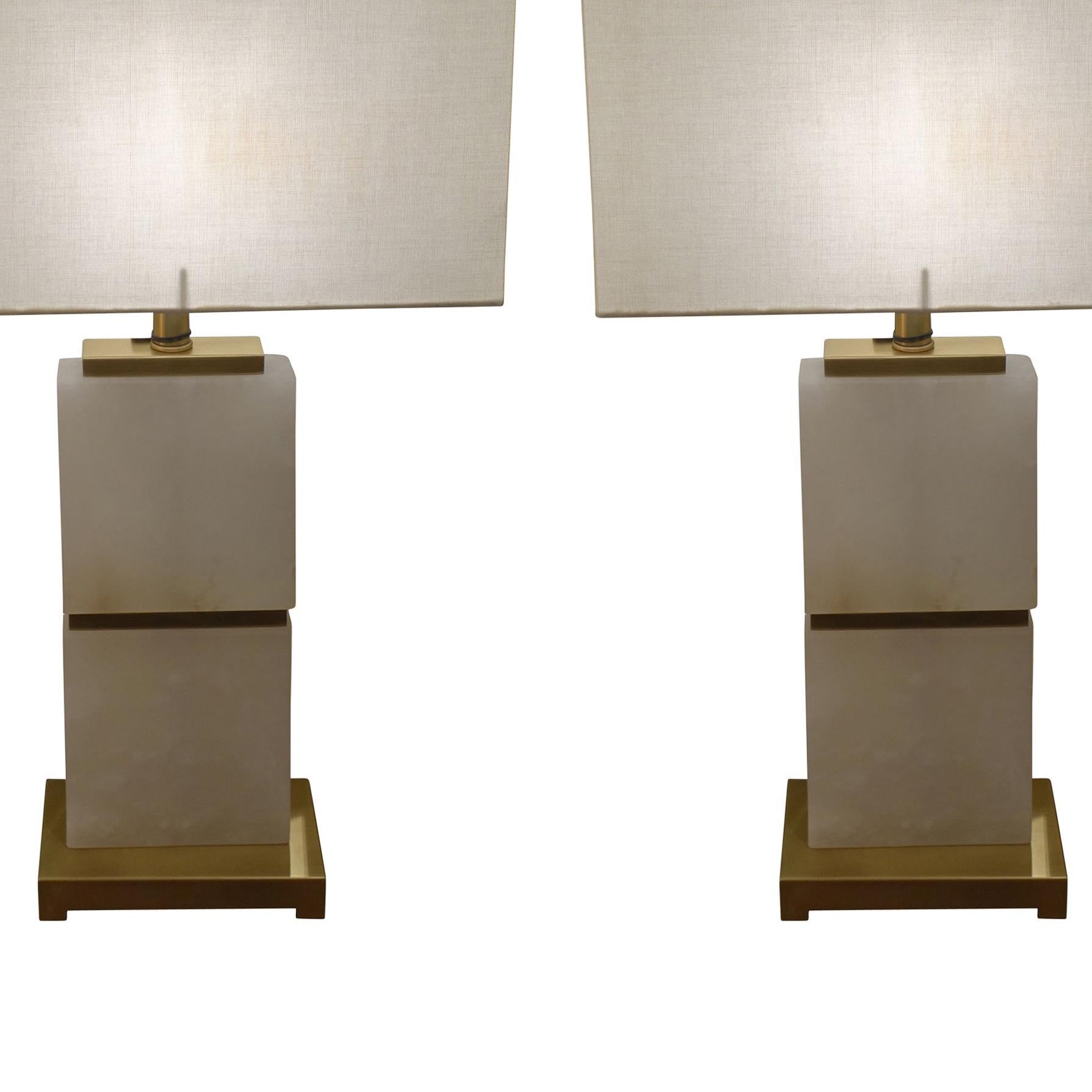 Contemporary Dutch pair of white alabaster lamps with horizontal brass trim details and brass base.
New rectangular shaped linen shade.
Measures: Shade 15.5