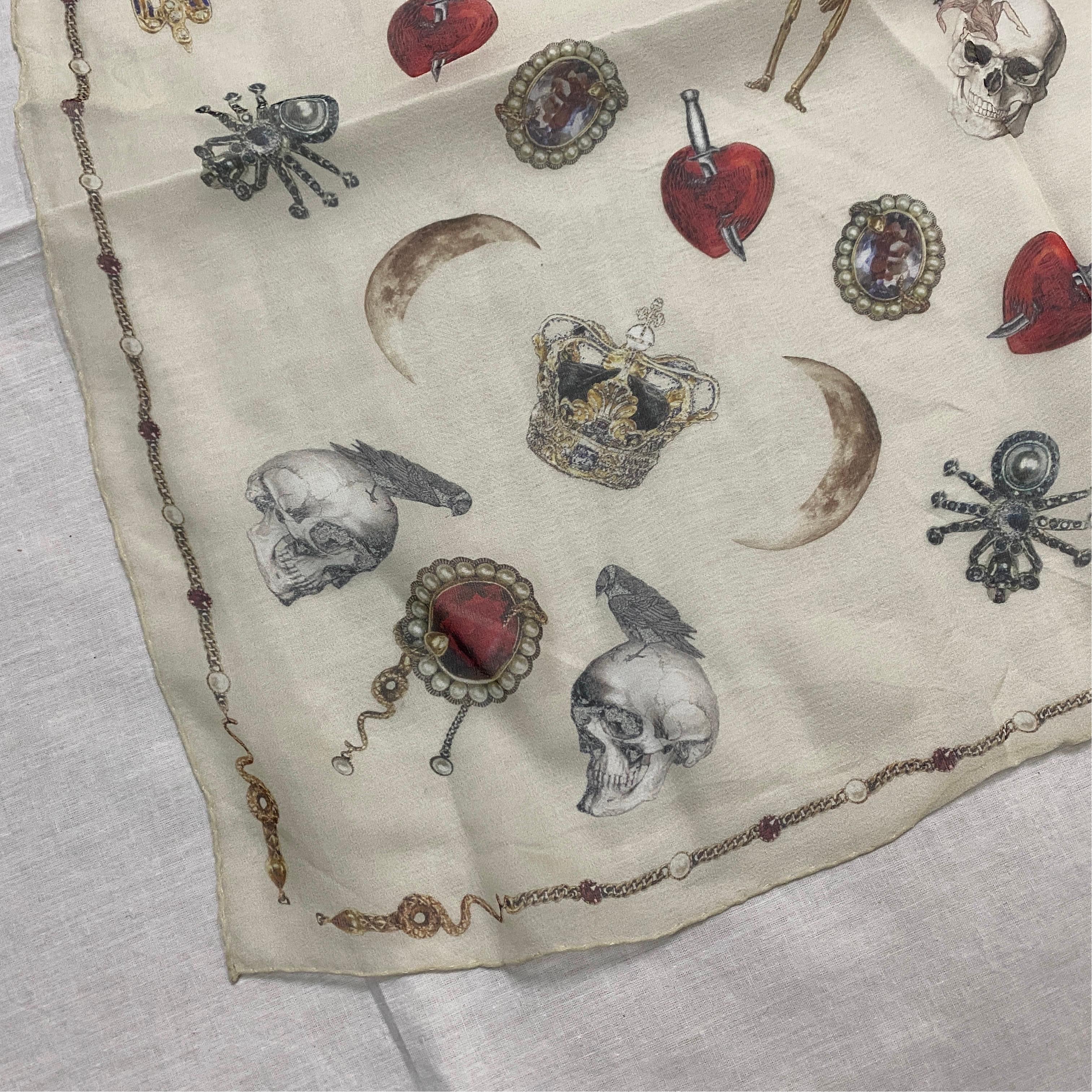 A Silk Scarf by Alexander McQueen manufactured in Italy, with the artist's iconic characteristic decors of skulls flora and fauna.It represents a luxurious and fashion-forward accessory. Alexander McQueen is a renowned British fashion designer known