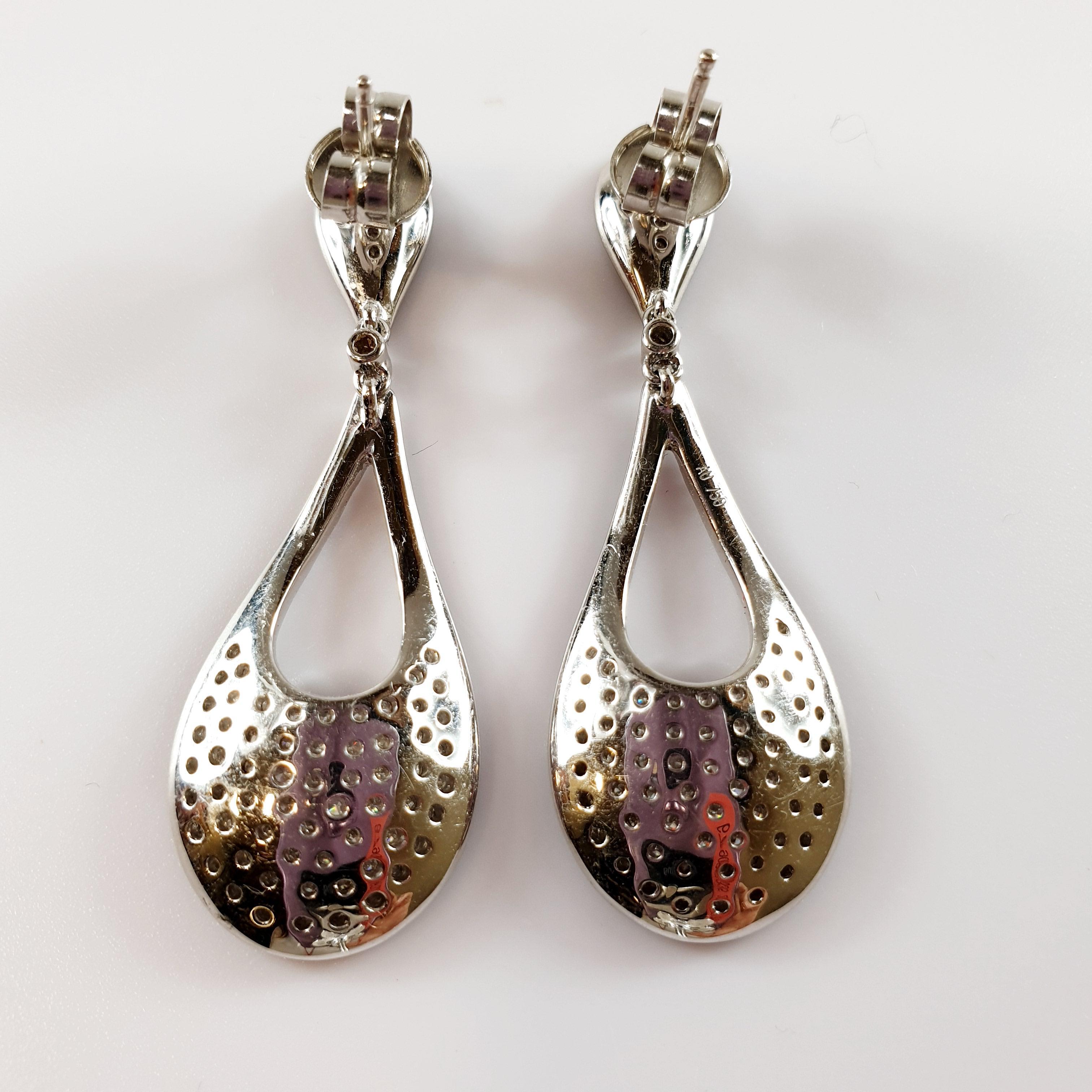 READY TO SHIP
*Shipment of this piece is not affected by COVID-19. 
Orders welcome!*
These pair of 18k white gold dangle earrings weight 8.8grams and measure 40mm or 1.50 inches
The pavé of black diamonds that surround the drops are 84 x 0,005ct