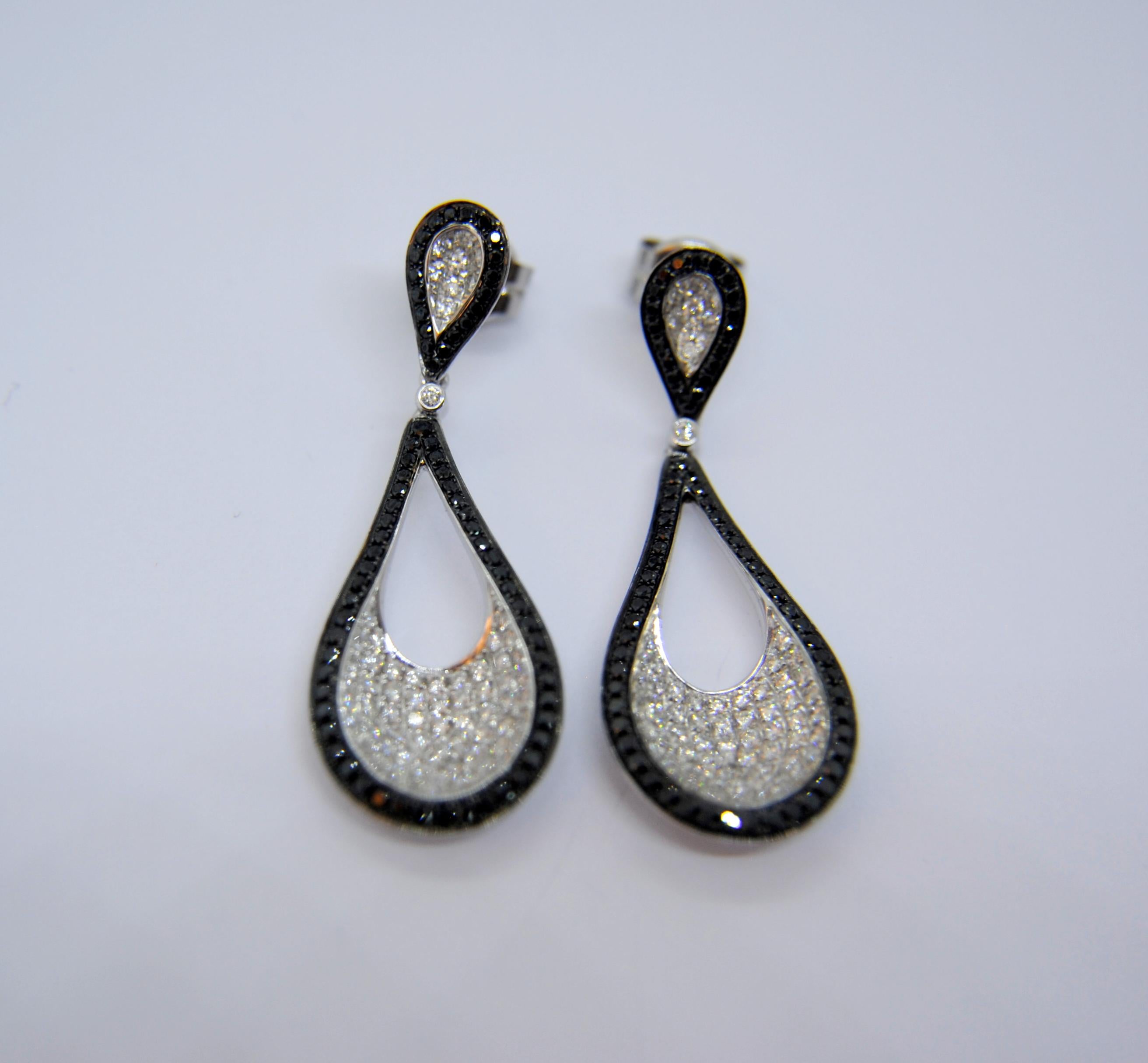READY TO SHIP
*Shipment of this piece is not affected by COVID-19. 
Orders welcome!*
These pair of 18k white gold dangle earrings weight 8.6grams and measure 40mm or 1.50 inches
The pavé of black diamonds that surround the drops are 84 x 0,005ct