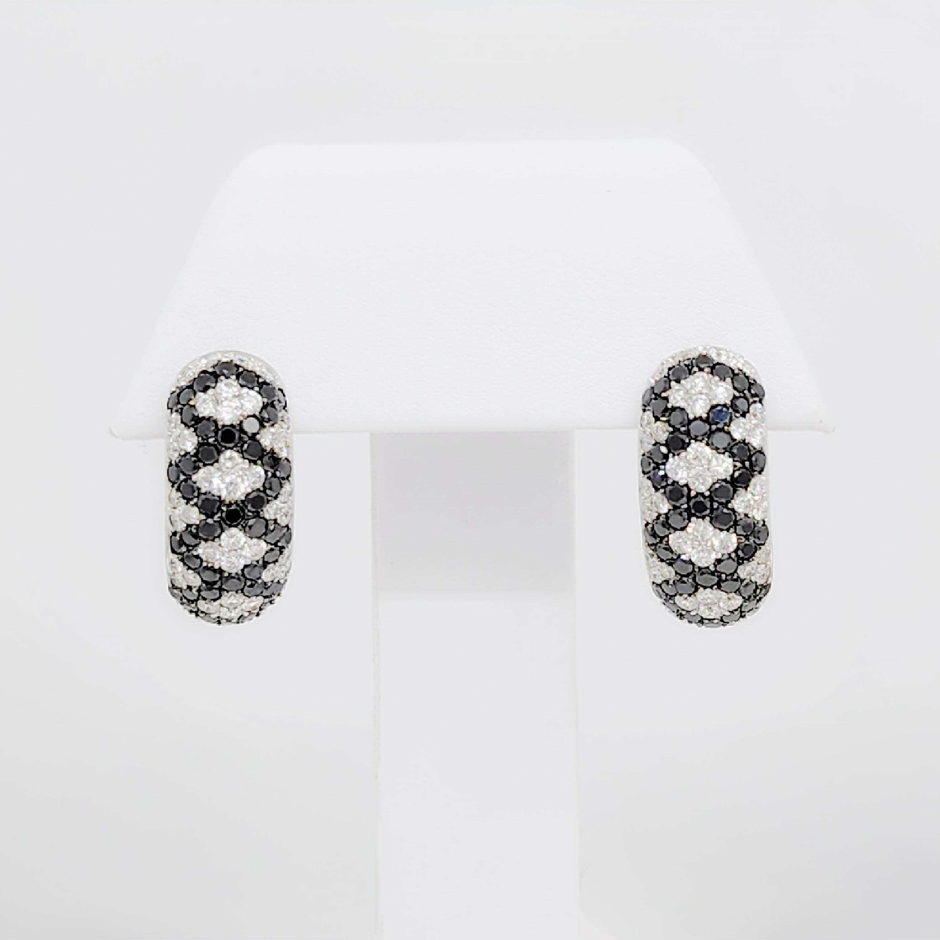Beautiful 1.10 ct. white diamond rounds with 1.30 ct. black diamond rounds in this fun design.  Handmade in 14k white gold.  These earrings are a great addition to any jewelry collection.