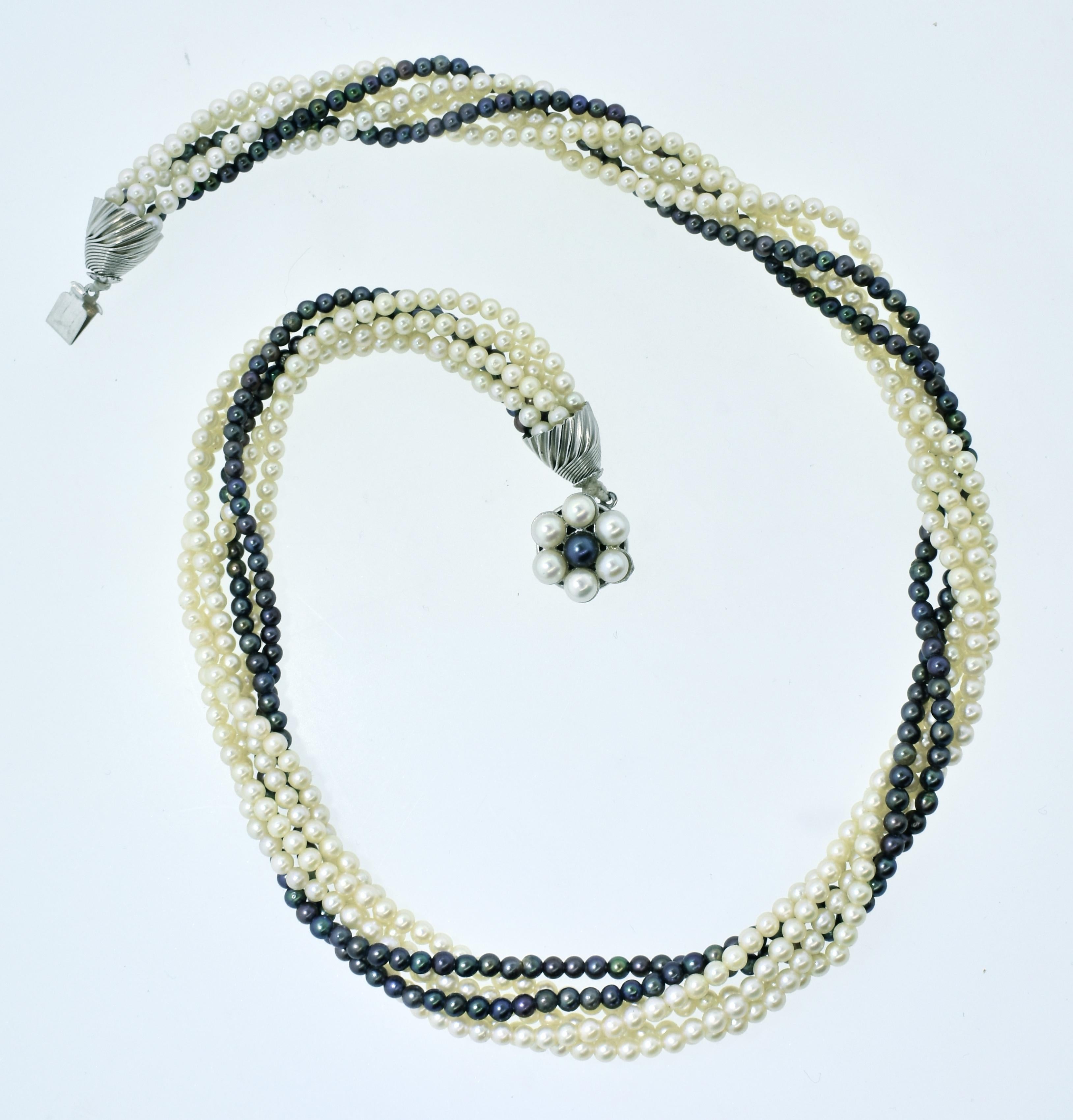 Pearl necklace possessing both fine white pearls and black pearls.  These pearls range in size from 2.5 mm. to 3.0 mm.  One can wear this lovely necklace slightly twisted or more so depending on the long and length one would like to achieve.  Either