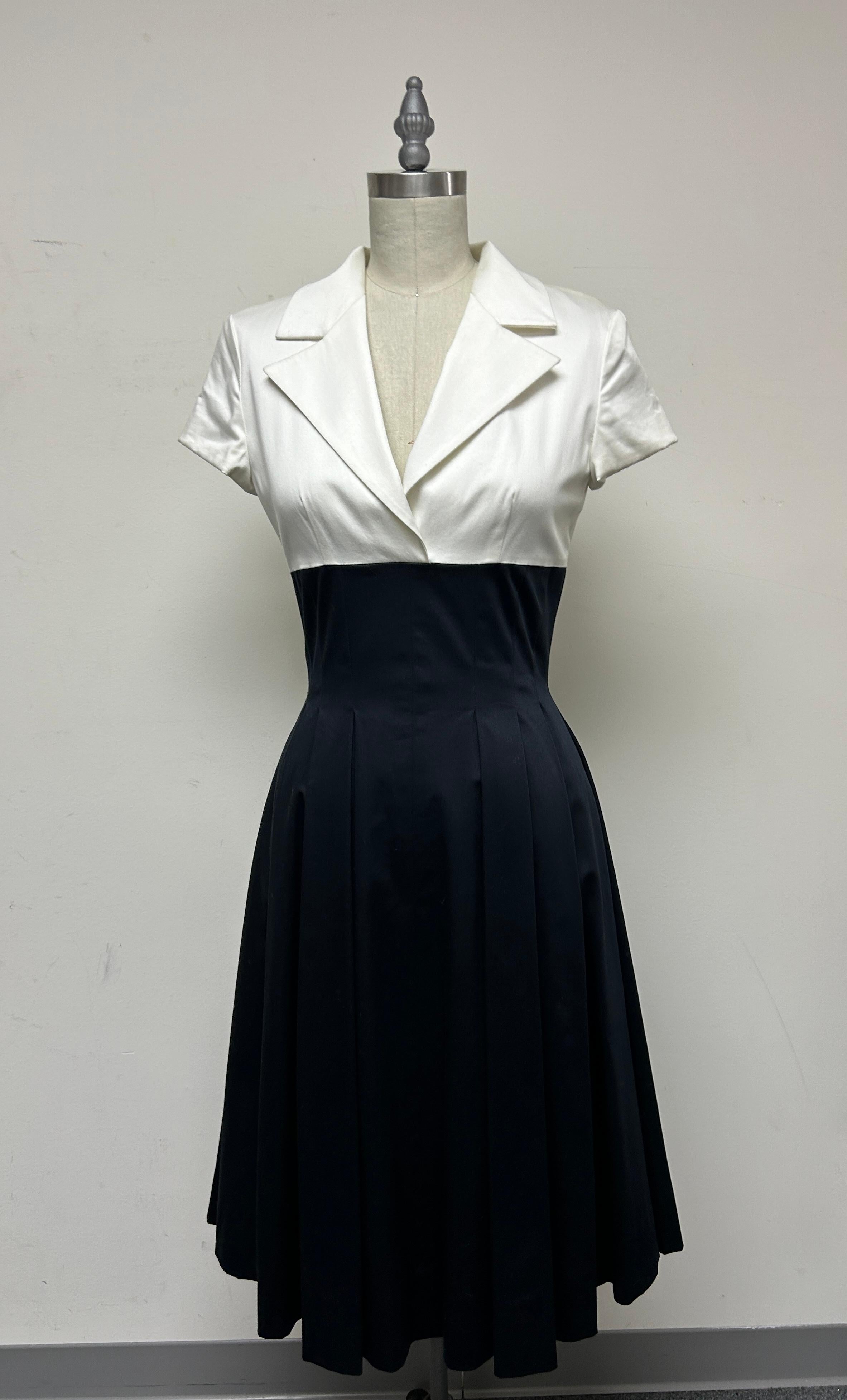 Black and White fitted shirt-dress in Swiss polished cotton. Will take you from day into evening for cocktails to dinner. It's the perfect transition dress for the end of summer into early fall. A timeless look and fun to wear. Fits snugly at the