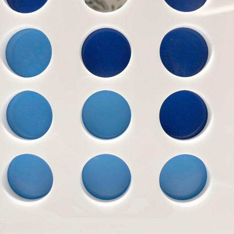 The classic game of Connect Four is reimagined. Crafted out of acrylic and lacquered white, the game features dark and light blue chips that are pleasing to the eye; allowing this piece to be kept out year round as decor. 

Measurements

13” H x