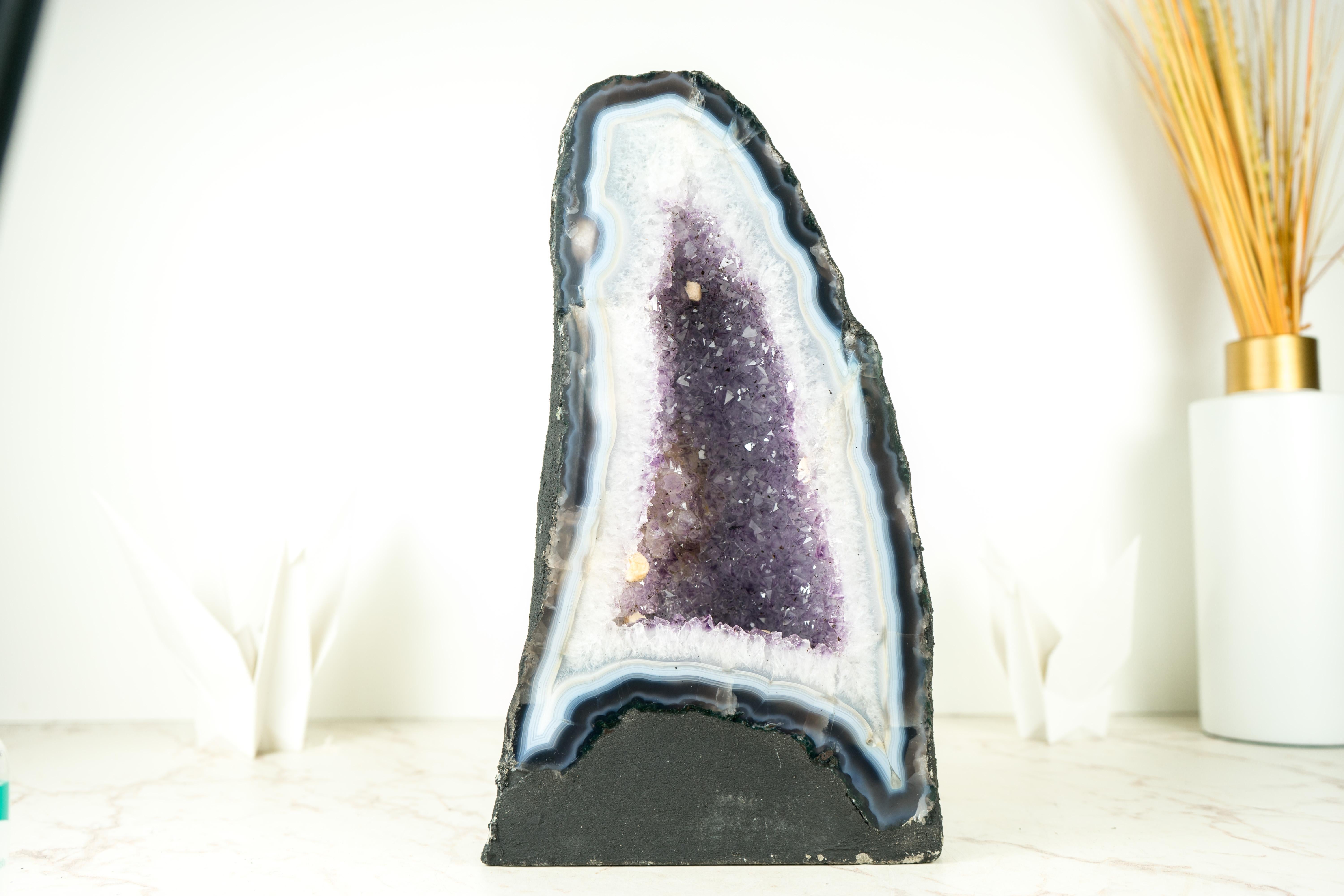 Agate Cathedral Geode: Gorgeous White and Blue Agate Laces with a Lavender Amethyst Interior

▫️ Description

A White and Blue Agate Geode that is meant to bring the nicest energies and will elevate your space, decor, or collection with its beauty