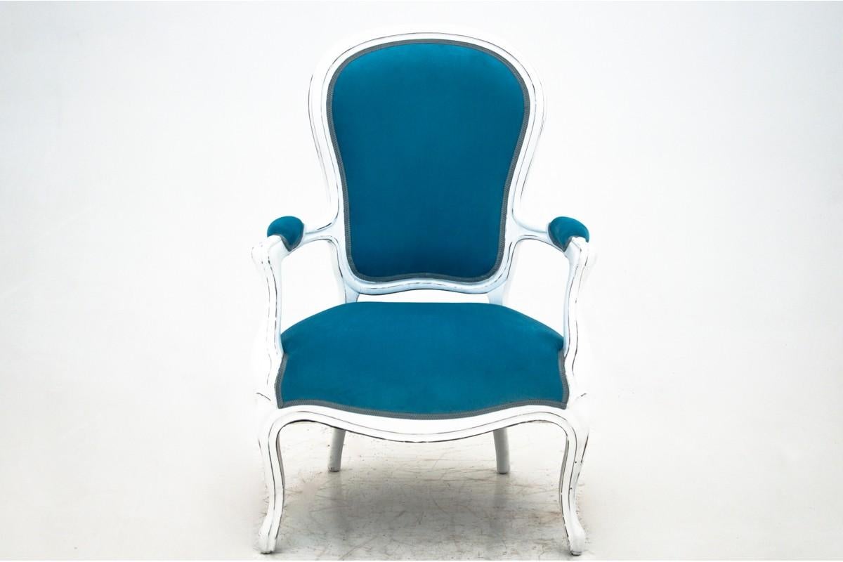 An antique armchair from the beginning of the 20th century. Furniture in very good condition, after professional renovation, upholstered with new fabric.