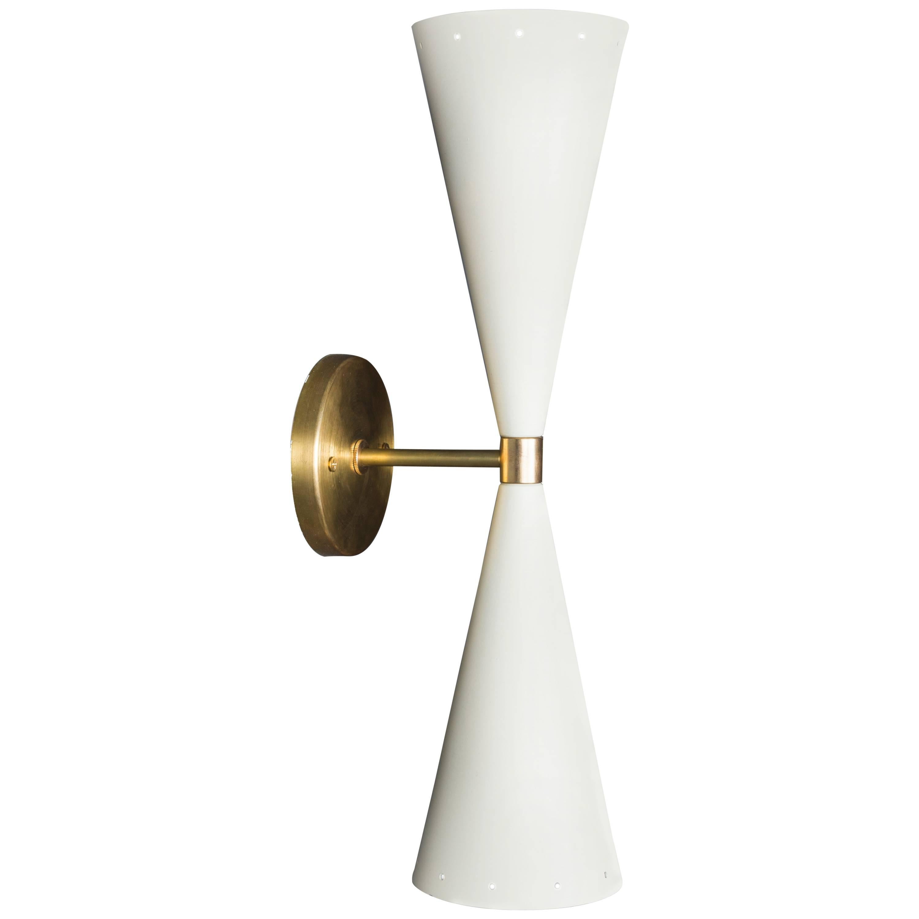 The double cone sconce features two tapered cones, in either black or white, with small perforations at both ends with a brass backplate and spacer. Shown here in white powdercoat and satin brass. Also comes in black. 

The Lawson-Fenning Collection