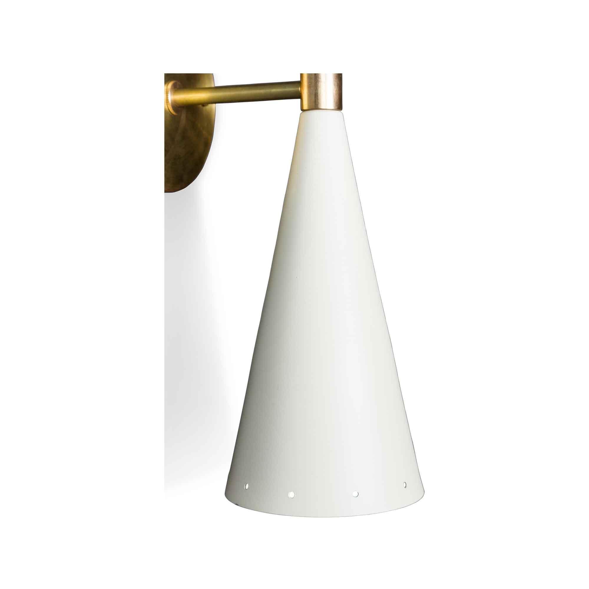 White and brass double cone sconce by Lawson-Fenning. The double cone sconce features two tapered cones, in either black or white, with small perforations at both ends with a brass backplate and spacer. 

The Lawson-Fenning Collection is designed