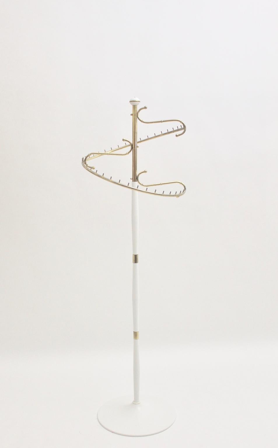 Rare swiveling white and brass mid-century modern fashion rack 1950s France.
This charming fashion rack was used in a fashion house.
It consists of tube steel white lacquered and brassed with a swiveling circle for clothes.
Worth to mention is that