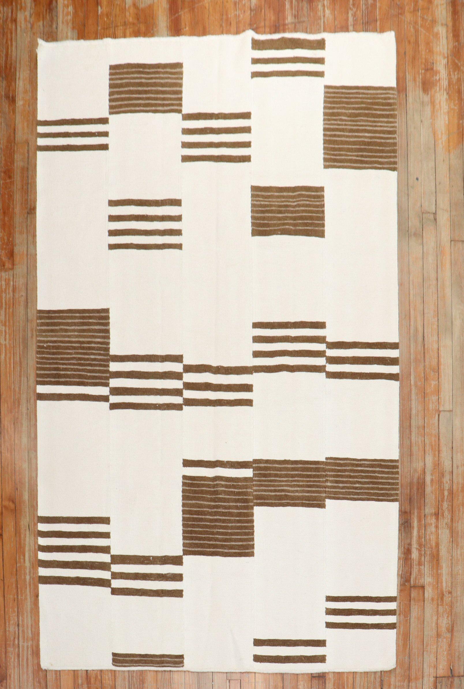 Intermediate-size Modern Turkish Kilim in ivory and brown made from recycled cotton and goat hair material giving it an old-world, vintage feel.

Measures: 4'10'' x 8'1''.