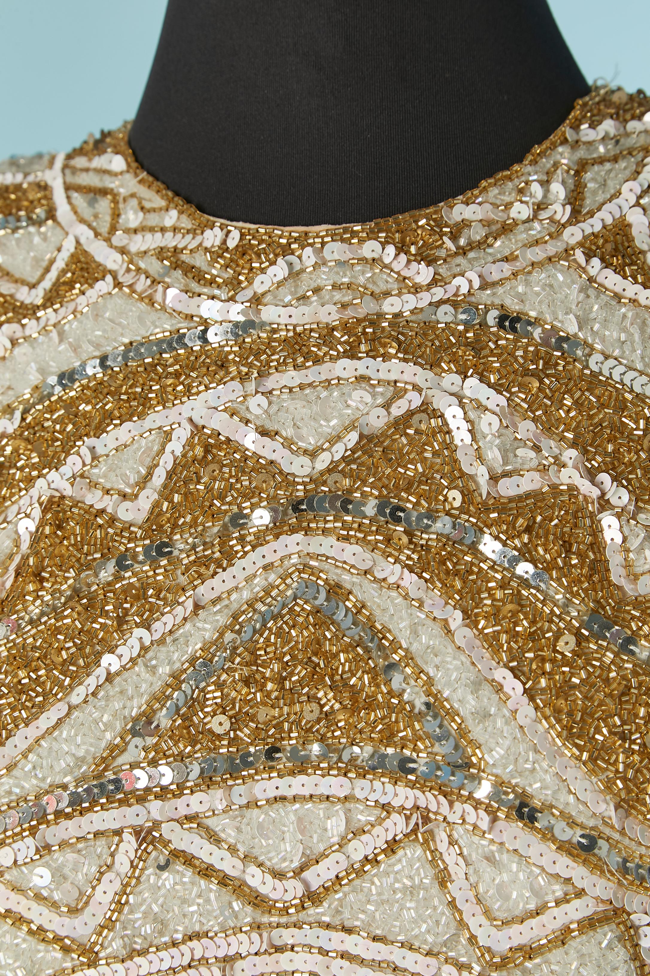 White and gold beaded cocktail dress . Shell composition: silk. Lining composition: rayon. Shoulder pad. Zip and hook&eye closure on the middle back. 
SIZE 8 (US) M 