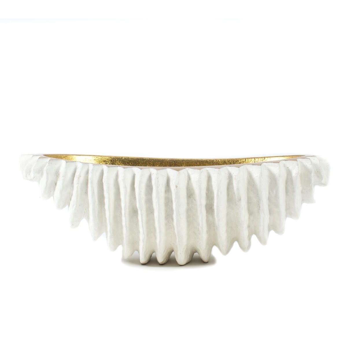 A dramatic, large scale white and gold centerpiece bowl by Mecox Gardens, meanings 24 inches in length.  Features a sculpture; seashell-like exterior and contrasting gilt interior.  Metal. 

Dimensions: 24 inches L x 13 inches D × 8 inches H