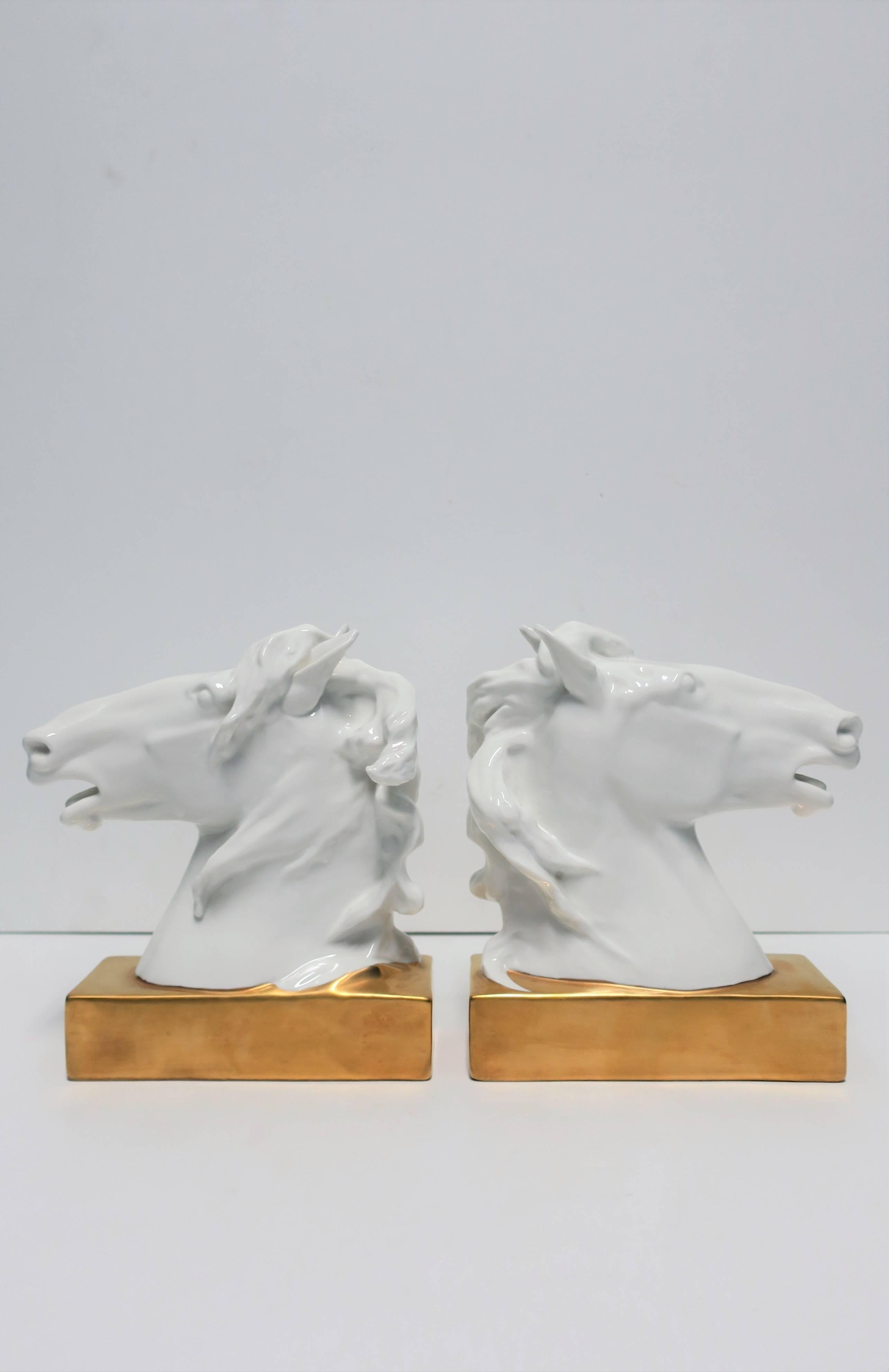 A beautiful and fine pair of white and gold porcelain horse or equine bookends or decorative objects/sculptures, circa late-20th century, Portugal. Pieces have beautiful detail in mane, snout, and ears, finished with a rectangular gold base. A great