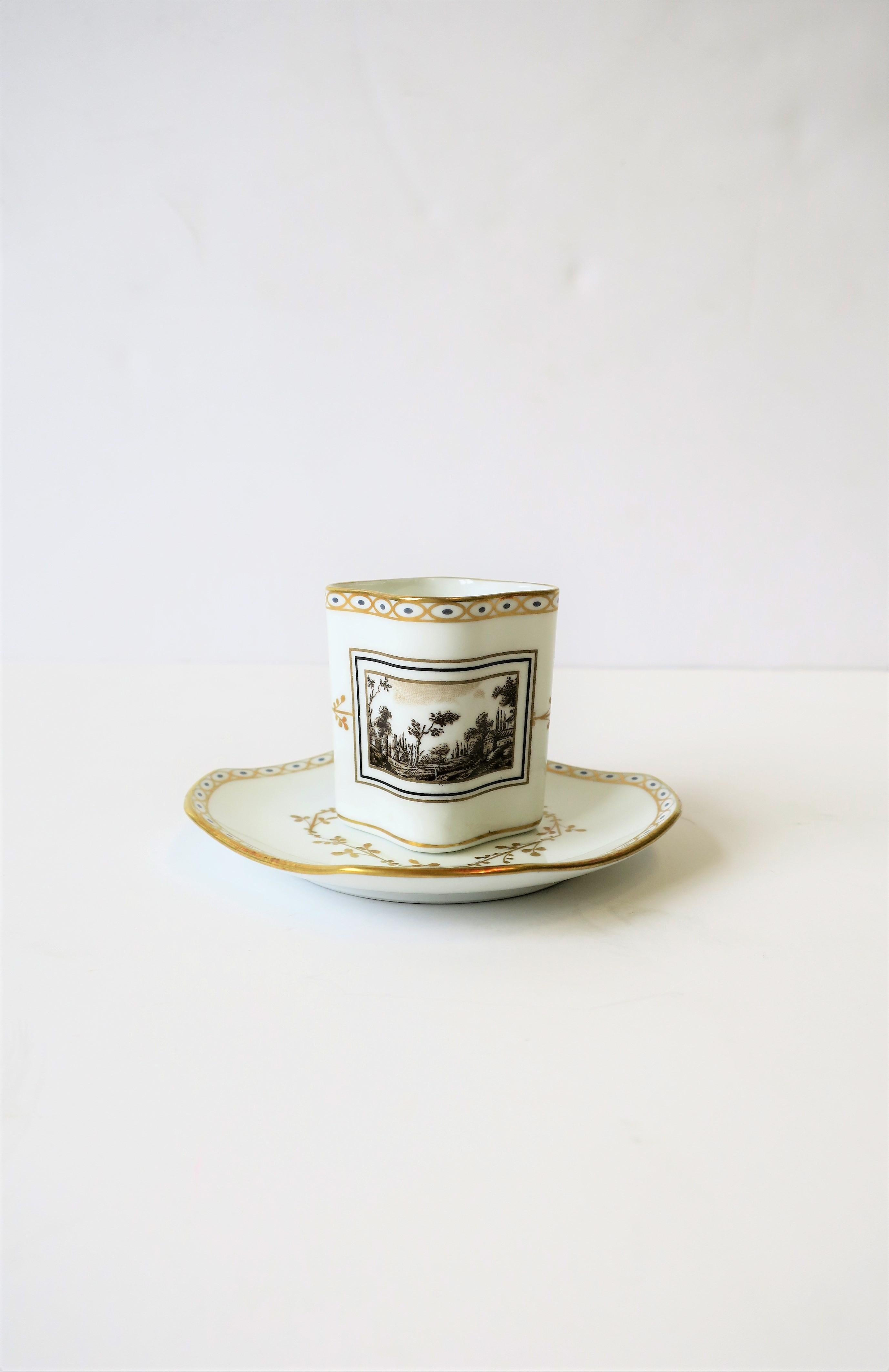 A beautiful Italian espresso coffee or tea demitasse cup and saucer 'Toscana' by designer Richard Ginori, circa mid-20th century, Italy. Porcelain cup and saucer have beautiful shape and decorative raised detail; gold and blue around edge, and
