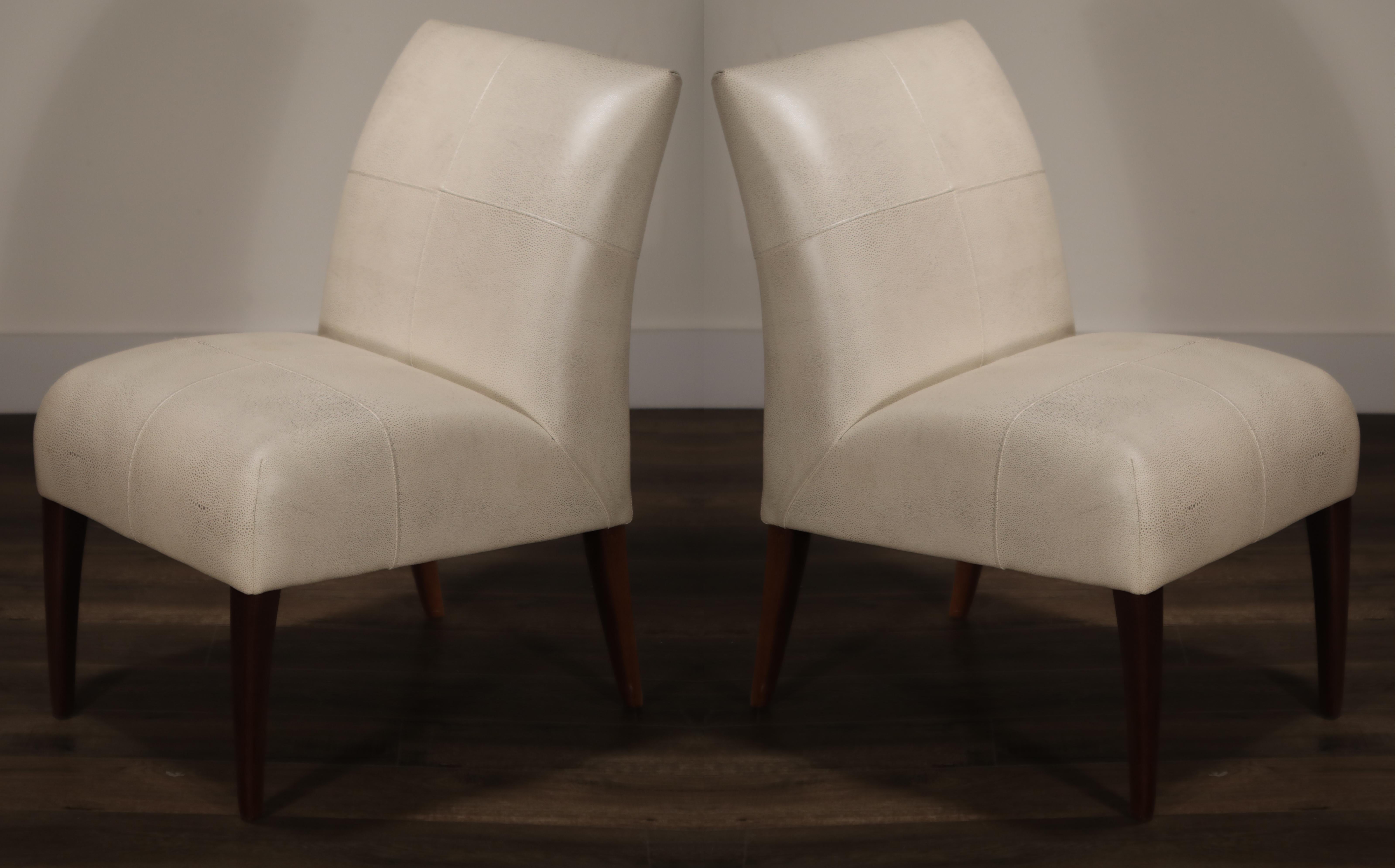 An opulent and incredibly stylish pair of Fendi side chairs, covered in high-quality white shagreen leather with flecks of gold tone. The incredible shagreen leather resembles shark and stingray skin with its tiny hills and valleys. The Fendi brand
