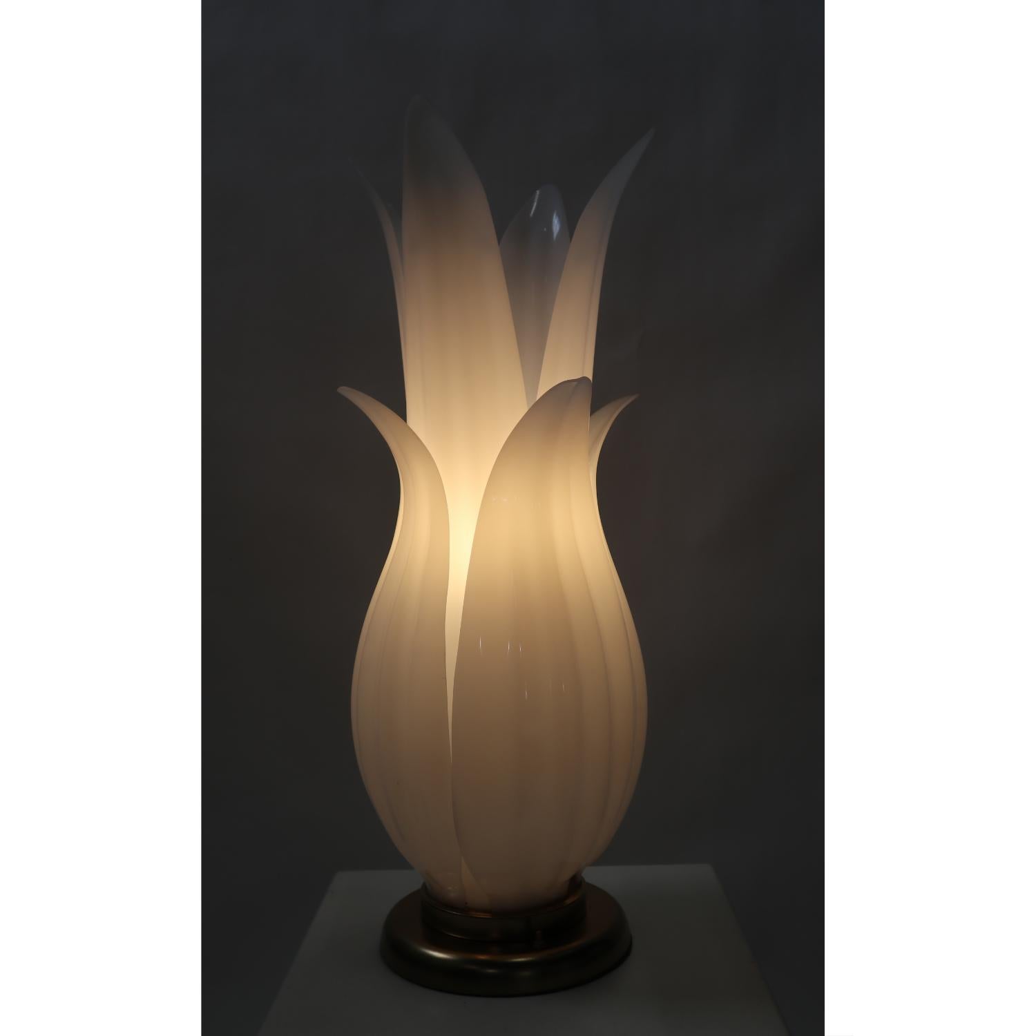 Captivating botanical table lamp featuring oversized white leaves emerging from a gold base. Designed after Rougier’s iconic Floriform lamps. The vintage late 1970s, early 1980s lamp evokes a luxurious spirit with the it’s grandiose size and obtuse