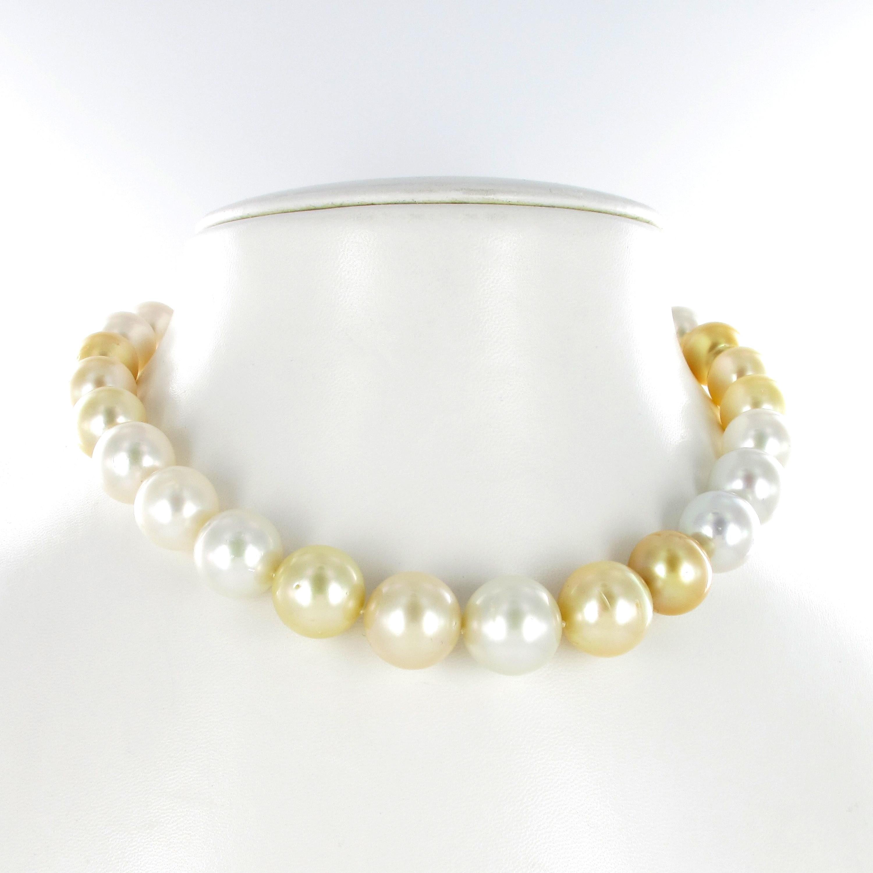 This strand consists of 29 white and golden South Sea cultured pearls from 12.8 mm to 16.5 mm. The bayonet/tube clasp in 18 karat yellow gold is elegantly hidden in the smallest cultured pearl. 
The pearls are of near round shapes, with a slightly
