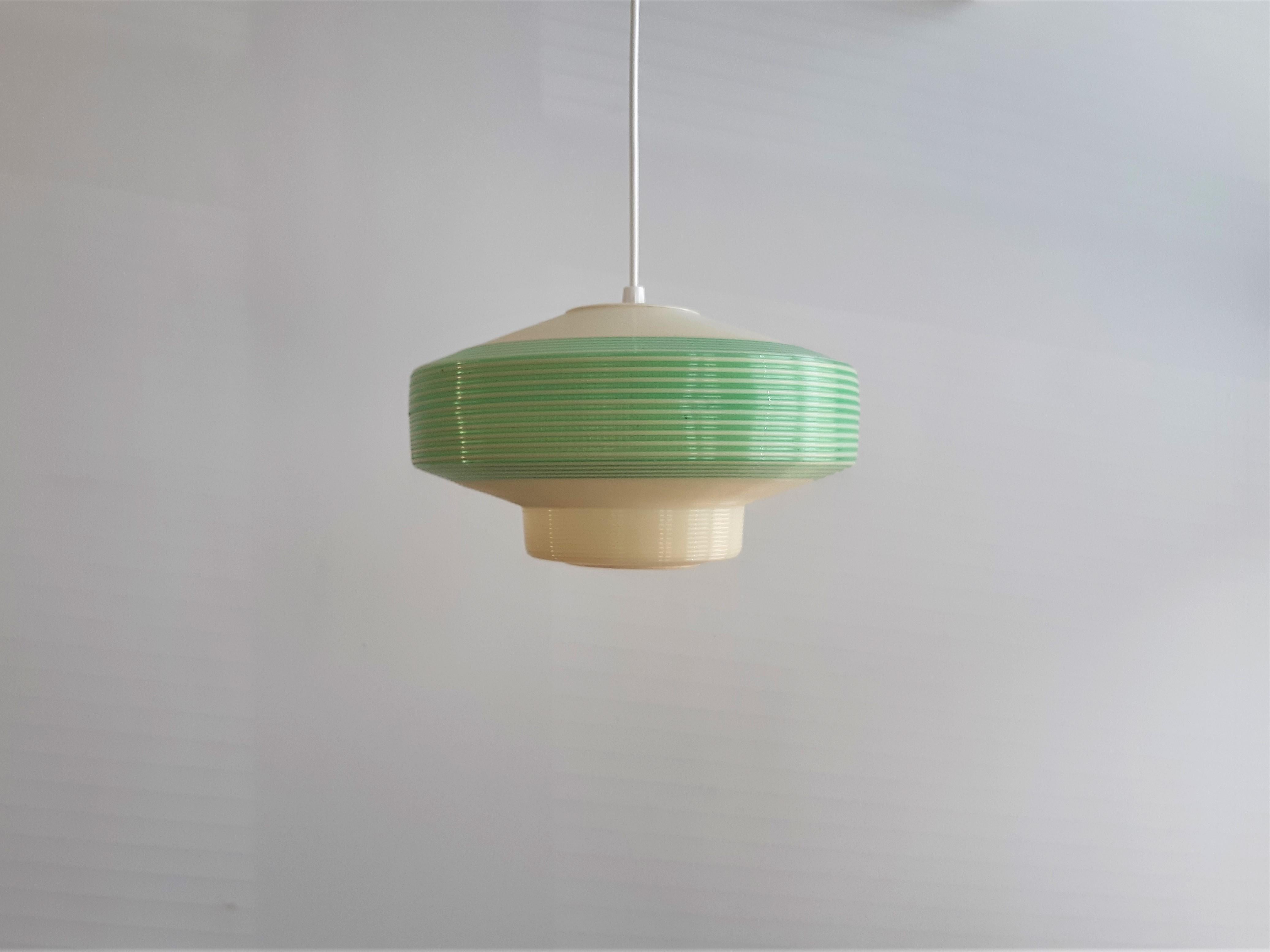 This elegant pendant lamp was made by Rotaflex, probably in the 1960's. It is made fully out of Cellulose Acetate (plastics) in white and green. The use of material spreads and diffuses the light very nicely. This lamp is marked by Rotaflex at the