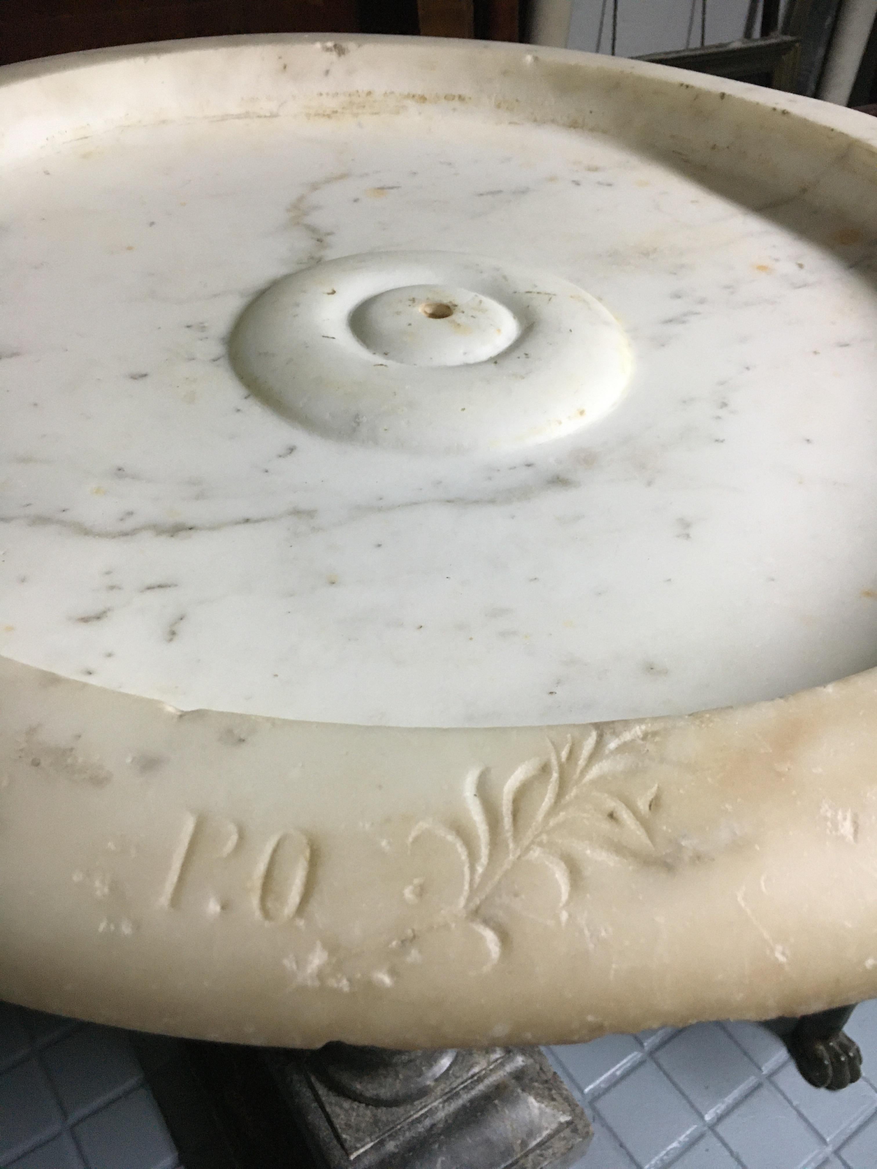Carrara marble fountain with its gray Sainte Anne marble base. 
French. 
circa 1700
18th century.
It works as a source.
It has a small restoration as can be seen in the photo.
The foot and the bowl are probably not born together, both are from