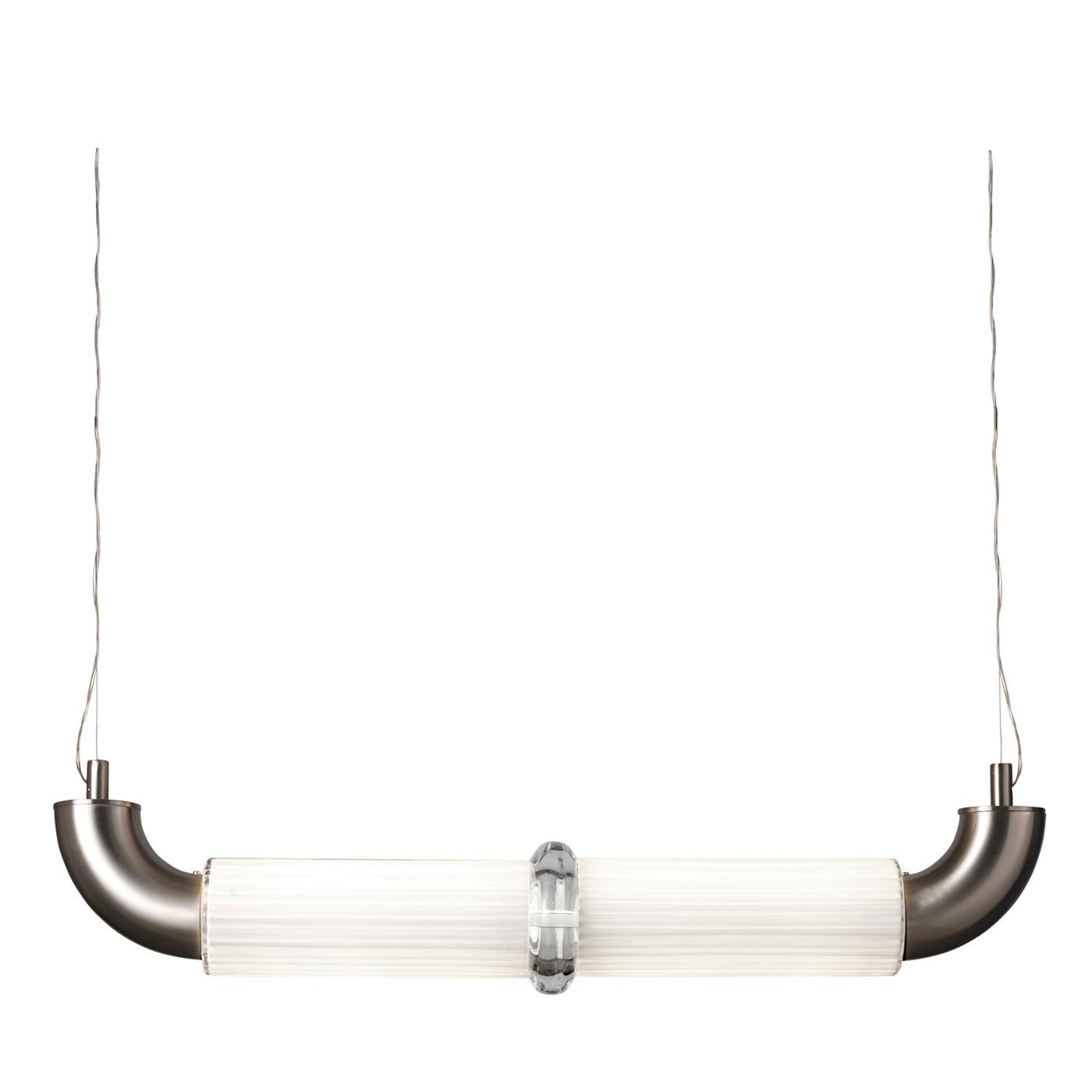 A captivating lighting piece distinguished by its essential silhouette, this pendant lamp hangs from two metal wires and showcases two curved cylindrical sections in satin nickel enclosing the horizontal diffuser in white glass that hosts a 40W LED