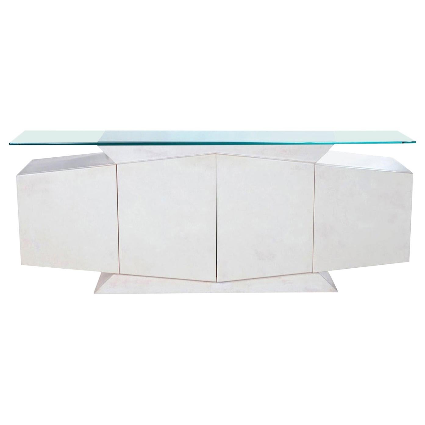 We're certain you've never seen anything quite like this and neither have we. Art Deco inspired pedestals on both the top and bottom set the tone for this Postmodern, geometric monumental masterpiece. This white lacquer credenza was designed by