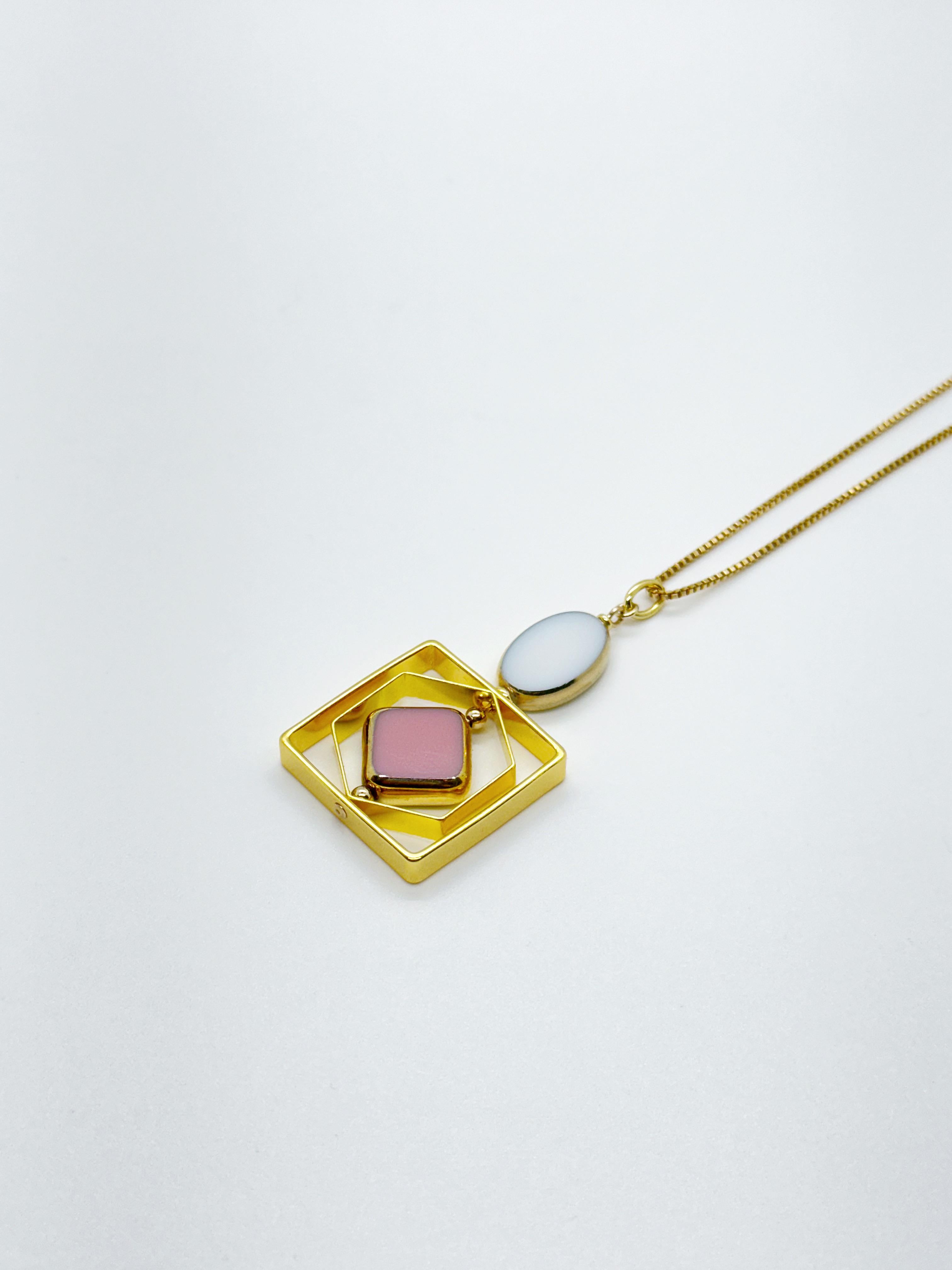 The pendant consists of white and pink vintage German glass beads and is finished with an 18-inch gold-filled chain. 

The beads are new old stock vintage German glass beads that are framed with 24K gold. The beads were hand-pressed during the