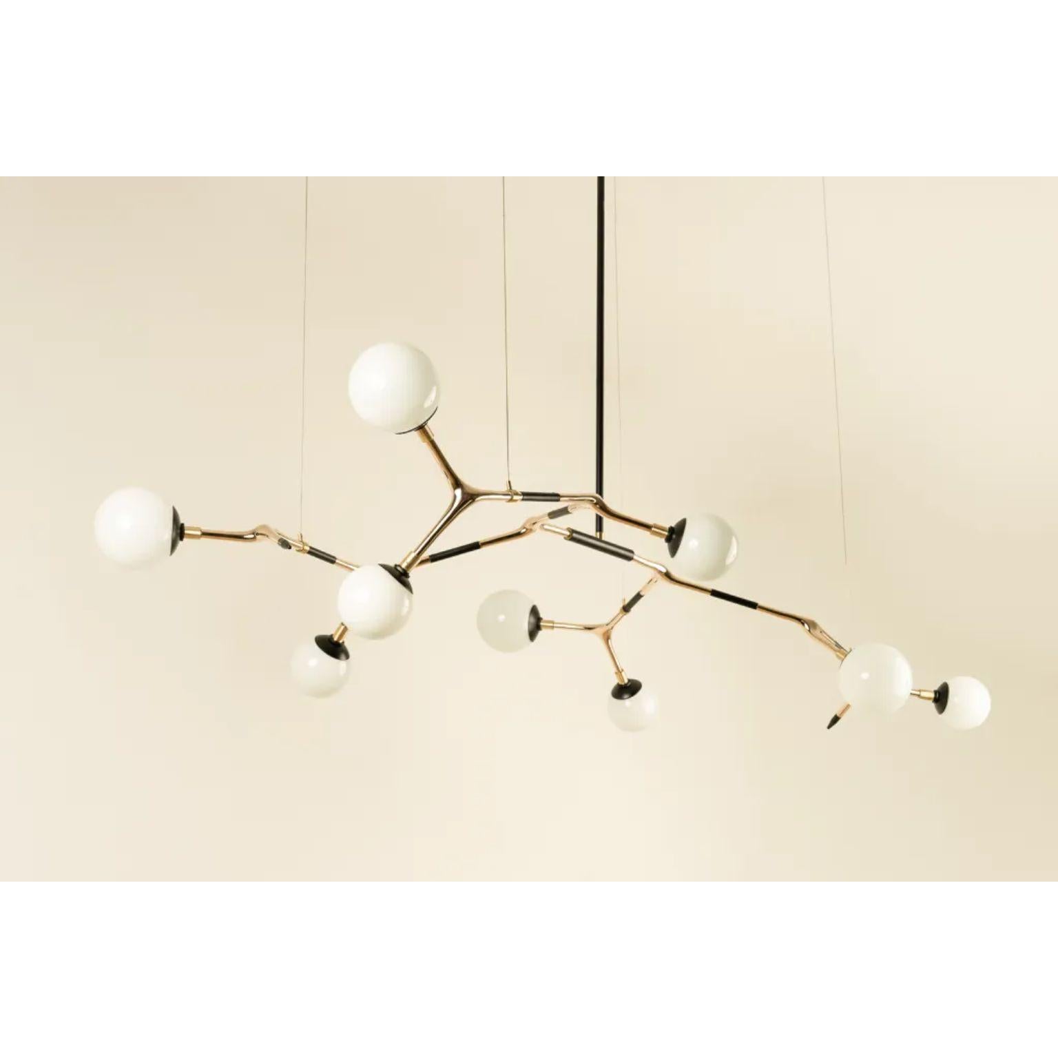 White and Polished Bronze Mantis 9 Pendant Lamp by Isabel Moncada
Dimensions: D 100 x W 190 x H 110 cm.
Materials: Cast bronze, blown glass and turned brass.

Mantis 9, discreet and elegant with measured dimensions. For a medium and sober table, the