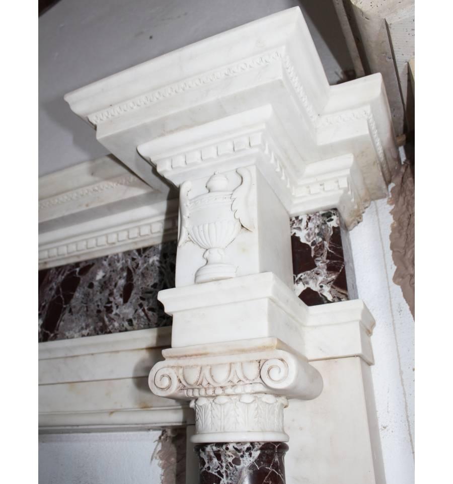 A classic fireplace made of two types of marble, white and red Alicante, with columns on the sides, all carved by hand.
Internal measures: 104 x 131.
