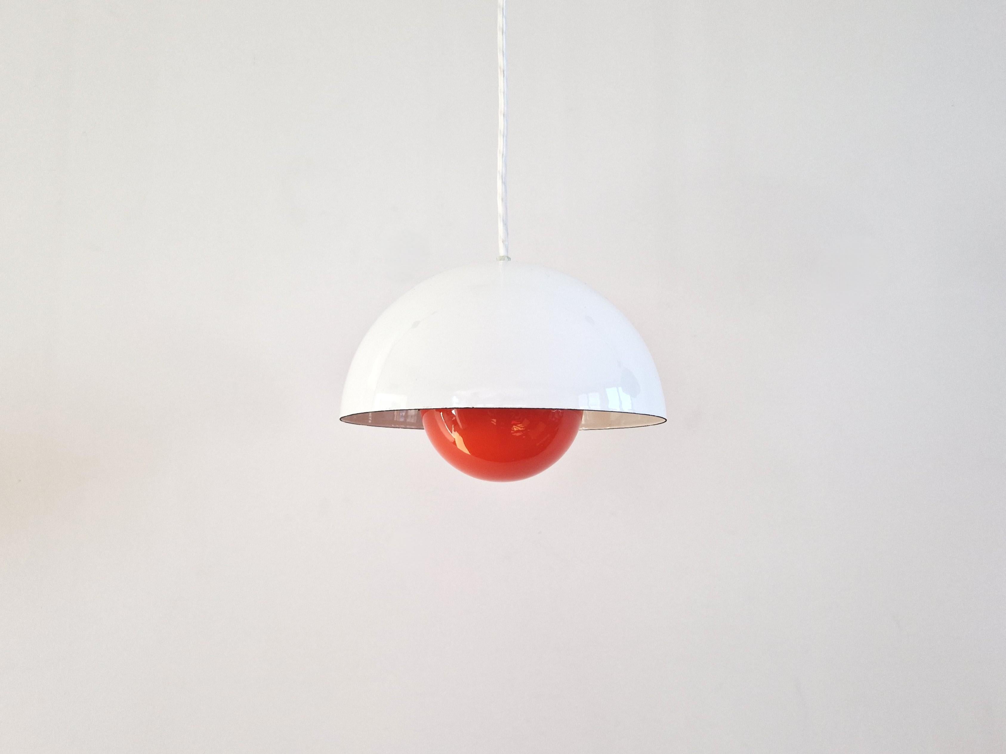 La lámpara colgante Flowerpot fue diseñada por Verner Panton para Louis Poulsen en 1968. Un bello clásico del diseño que sigue fabricándose. Esta lámpara es una versión antigua y tiene una pantalla esmaltada en blanco con un reflector esmaltado en