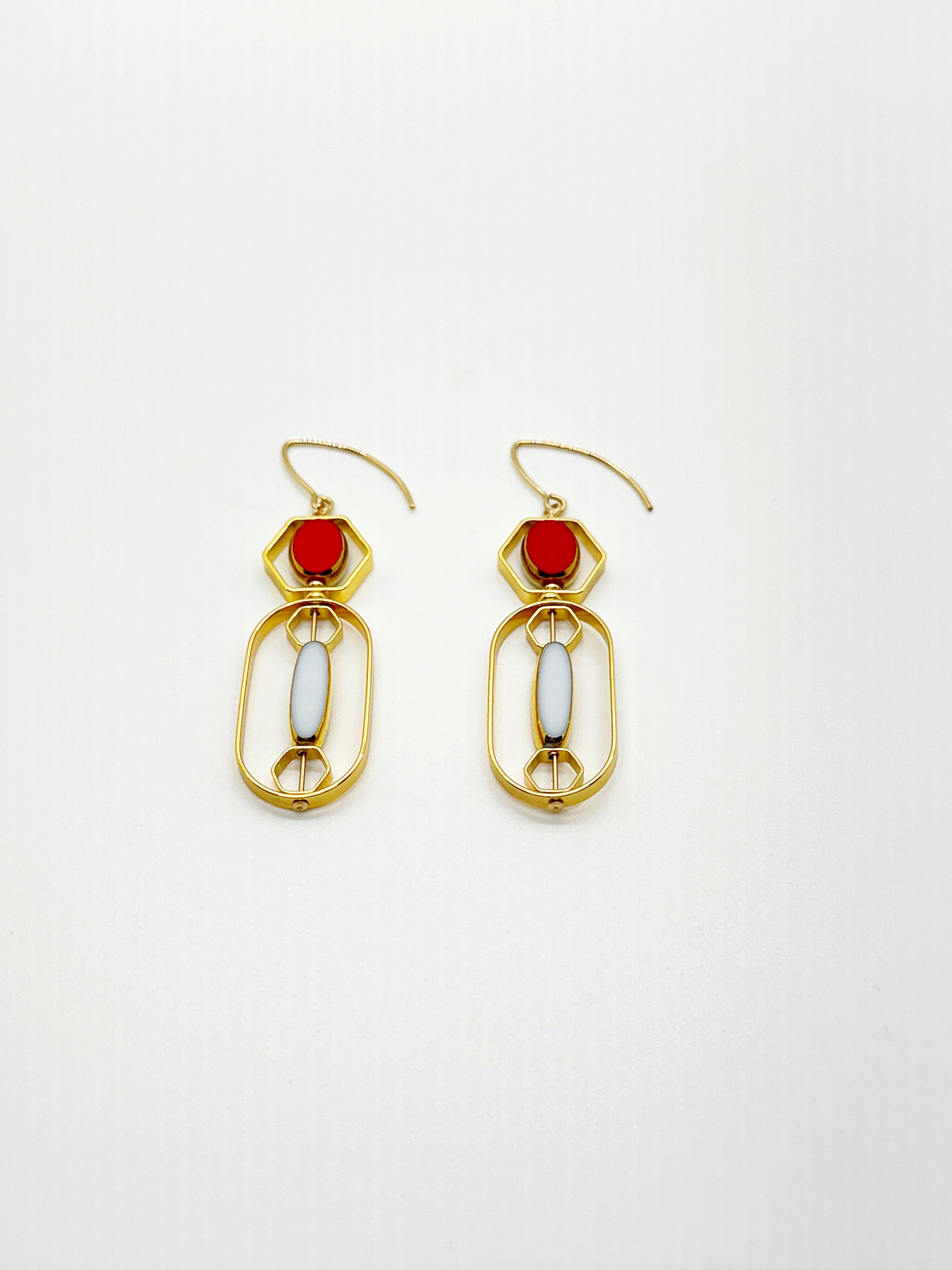 The earrings are light weight and are made to rotate and reposition with movement.

The earrings consist of small red oval and long white oval shaped beads. They are new old stock vintage German glass beads that are framed with 24K gold. The beads