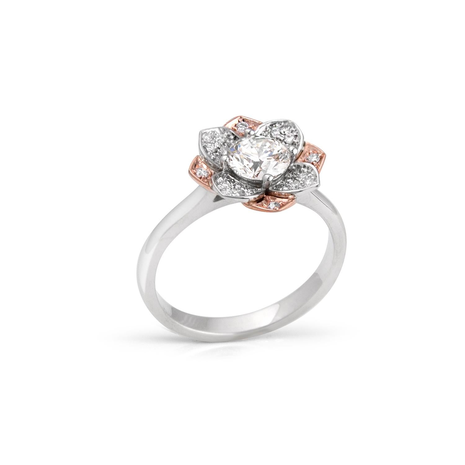 Flower ring in 14kt rose and white gold featuring a 0.70ct K VS1 round brilliant center diamond and pave' set petals with 28 diamonds equal to 0.19ct total. Ring size 6 1/2. Sizing up or down 2 sizes included in price. GIA number 2177065899.