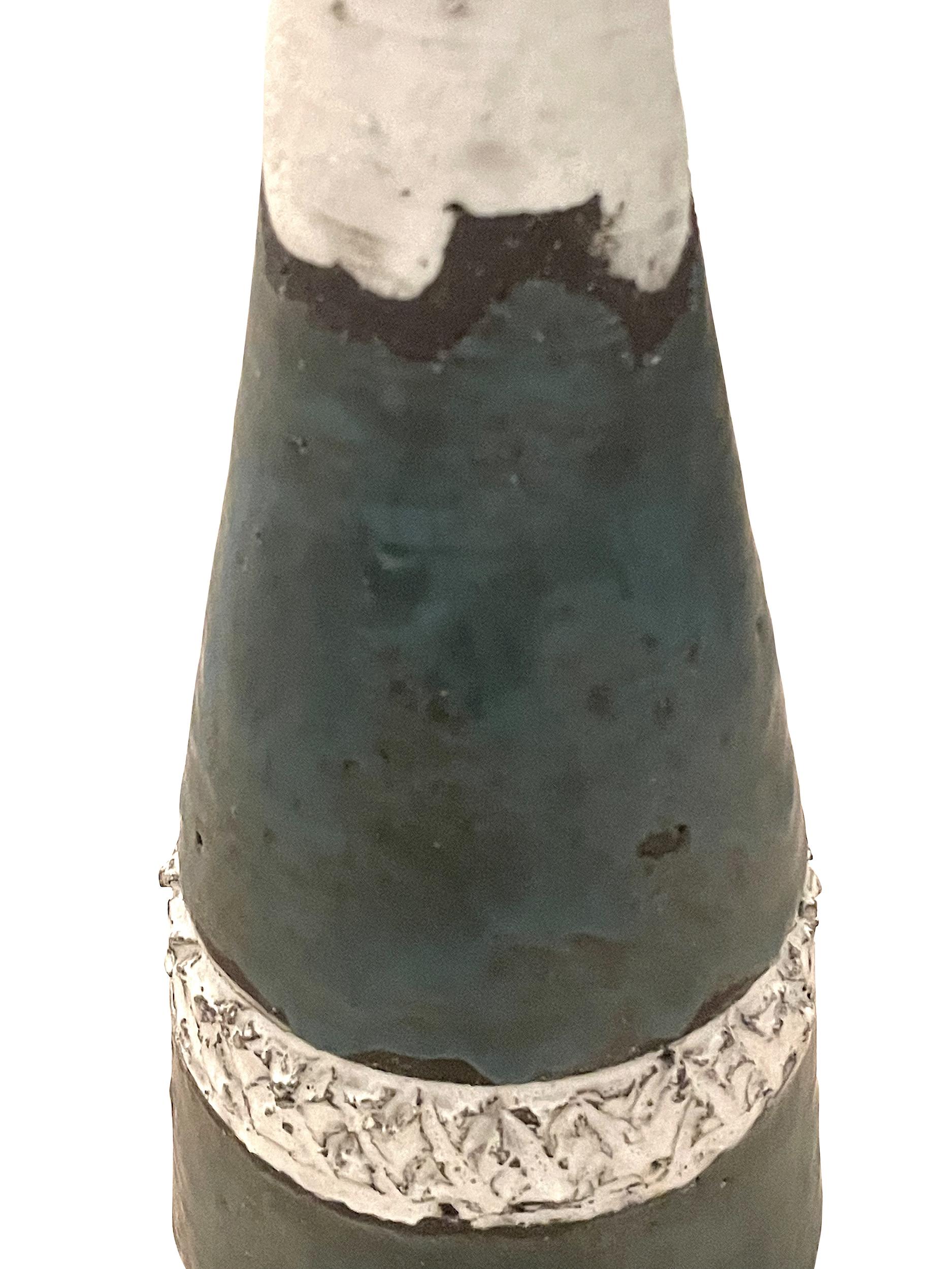 Mid Century Belgian bottle shaped vase.
Thin mouth opening.
Textured white surface with bands of top and bottom in teal.
