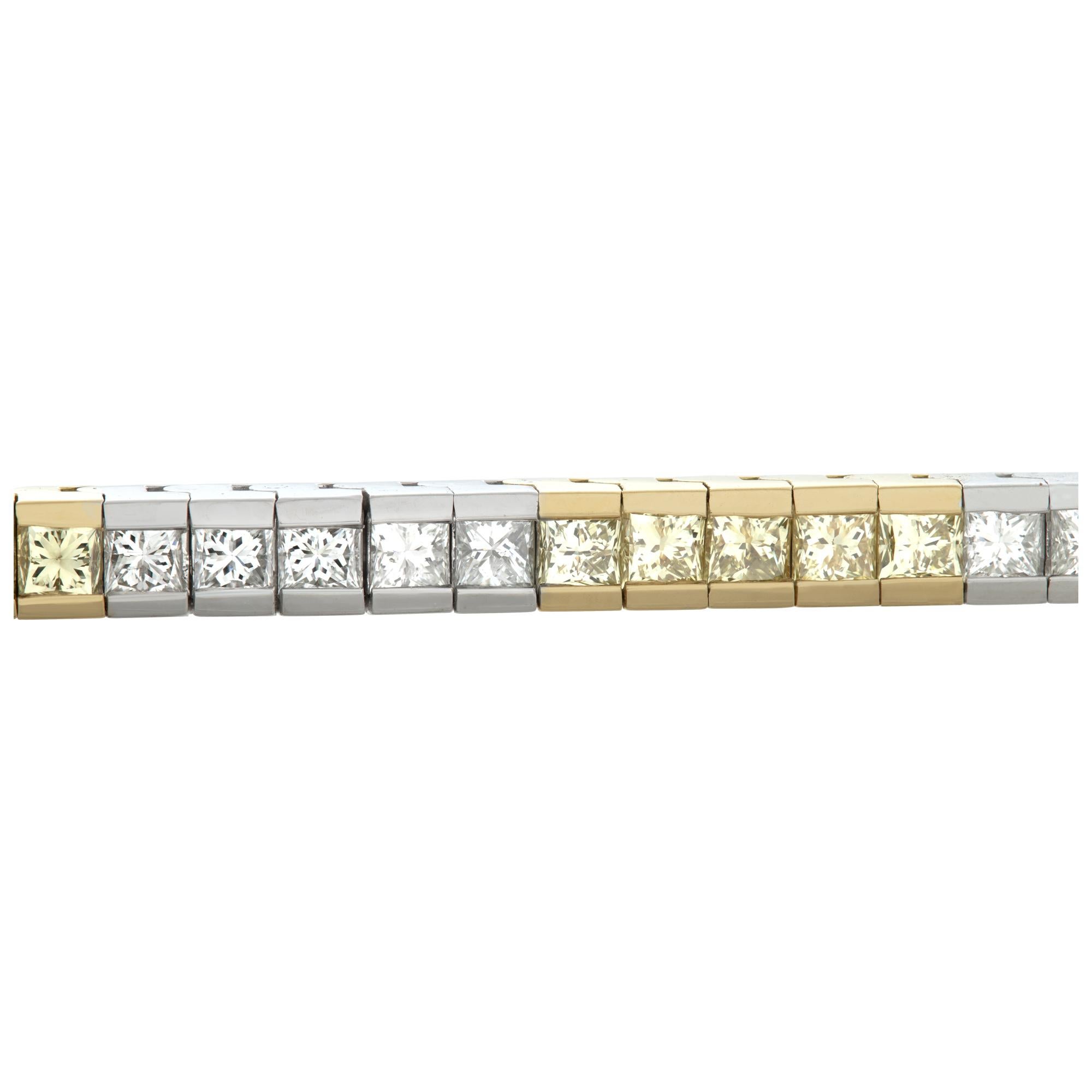 White & yellow diamond line bracelet in 18k white and yelllow gold. Approximately 2.80 carats in white diamonds (H-I color, SI clarity) and 3.35 carats in yellow diamonds. 7 inch length.
