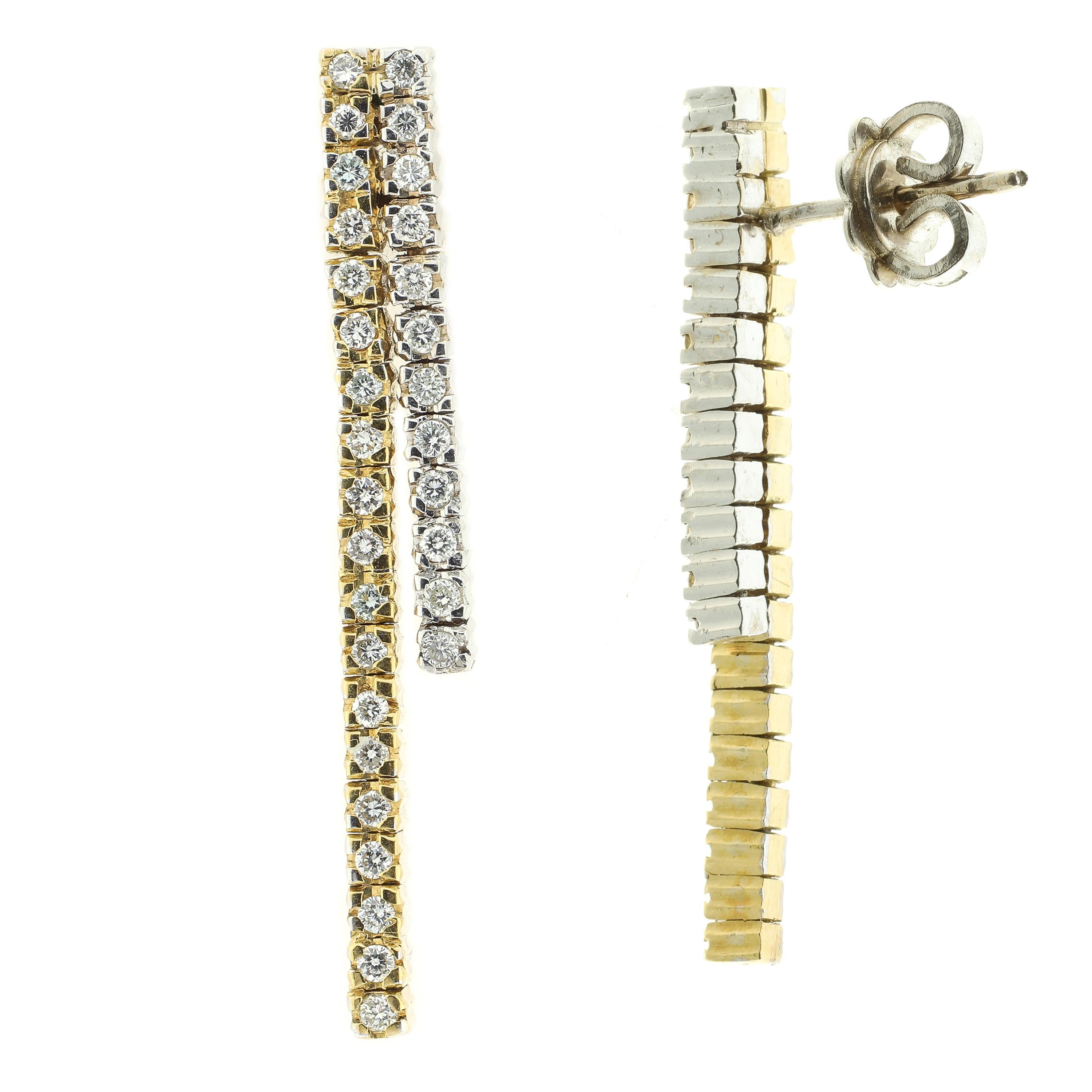 These modern drop earrings are masterfully handmade from a luxurious combination of white and yellow 18-karat gold which partner perfectly to set off two rows of gorgeous white diamonds.  

These earrings have post backs with butterfly clips and