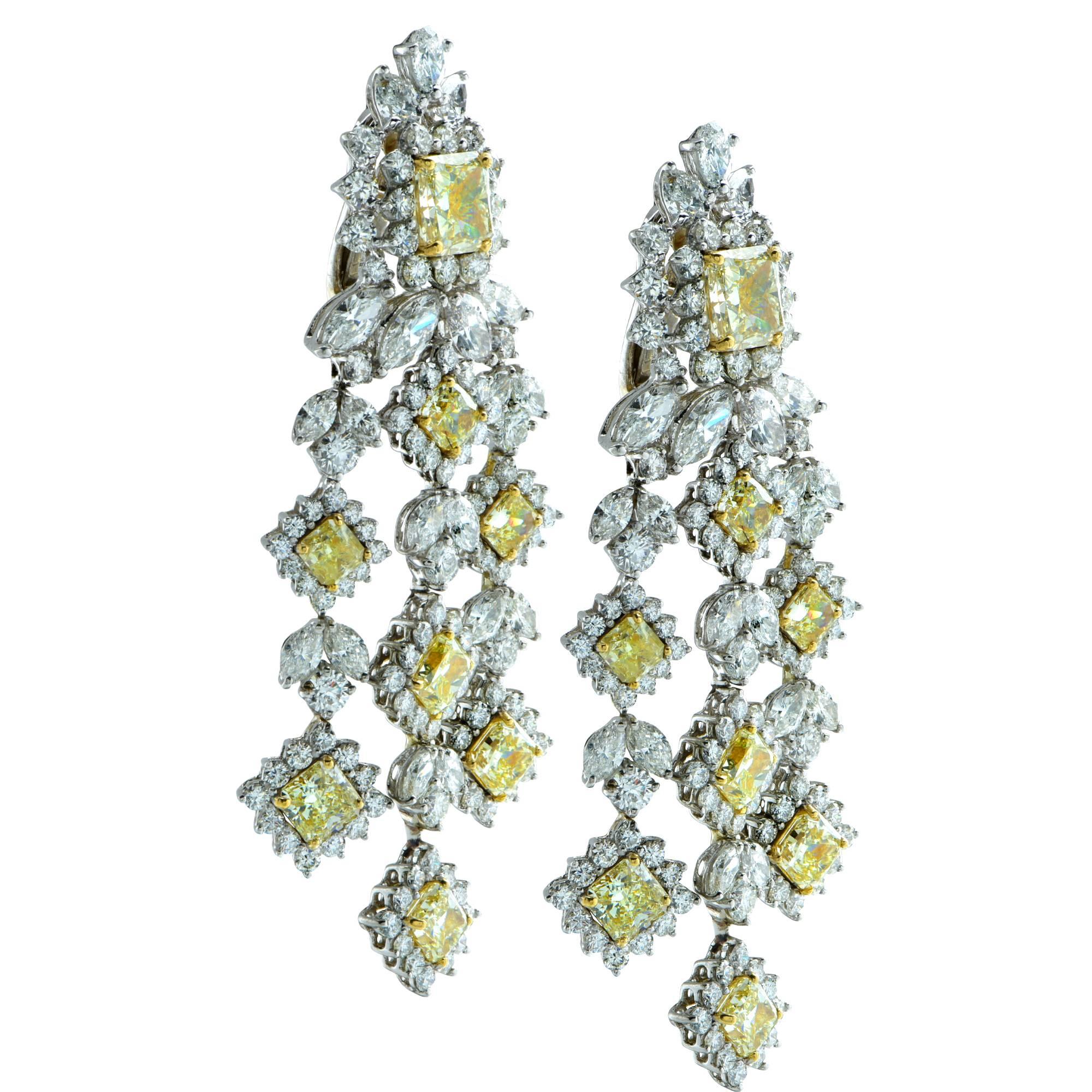Make a statement with these stunning 18 karat white gold chandelier dangle earrings featuring two yellow radiant cut diamonds weighing approximately 6 carats total weight and 14 yellow radiant cut diamonds, weighing approximately 10 carats total