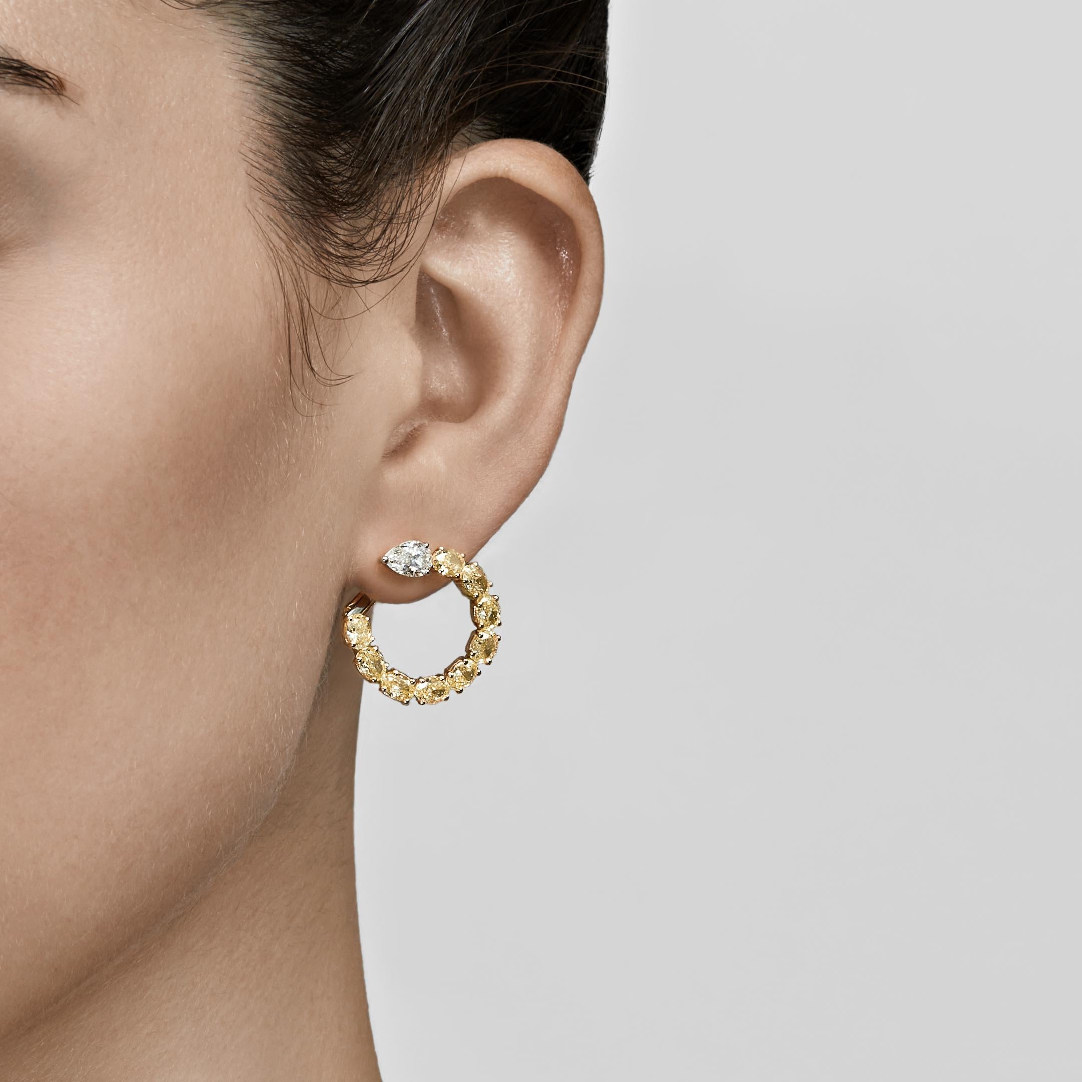 Hoop earrings are a fine jewelry necessity that works for so many occasions. Small huggie hoop lend polish to a humble errand run, while a large, luxurious pair becomes the focal point of your ensemble. These white and yellow diamond hoop earrings