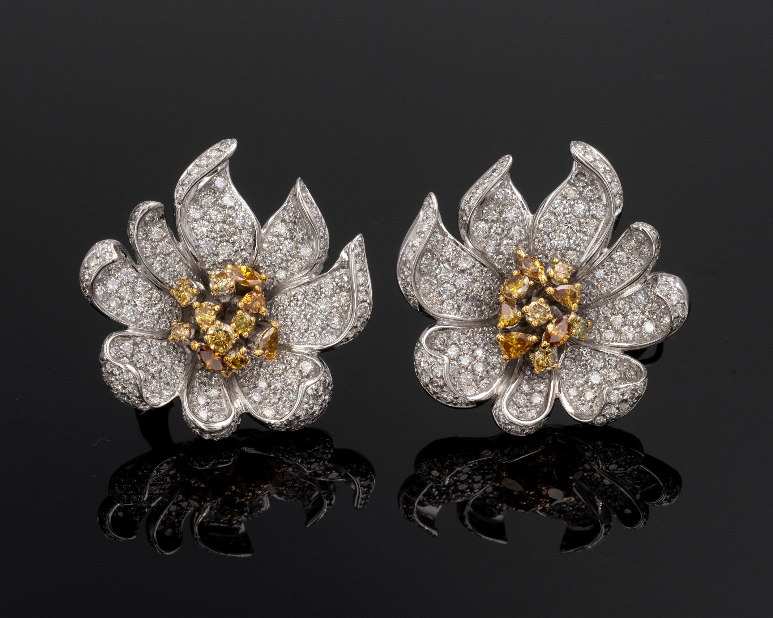 Impressive Flower earrings: the exquisitely shaped petals are pavé set with white diamonds ( F/G-VVS/ VS) the center of the flower is made of natural fancy intense yellow coloured diamonds set on yellow gold. The make is excellent; the 