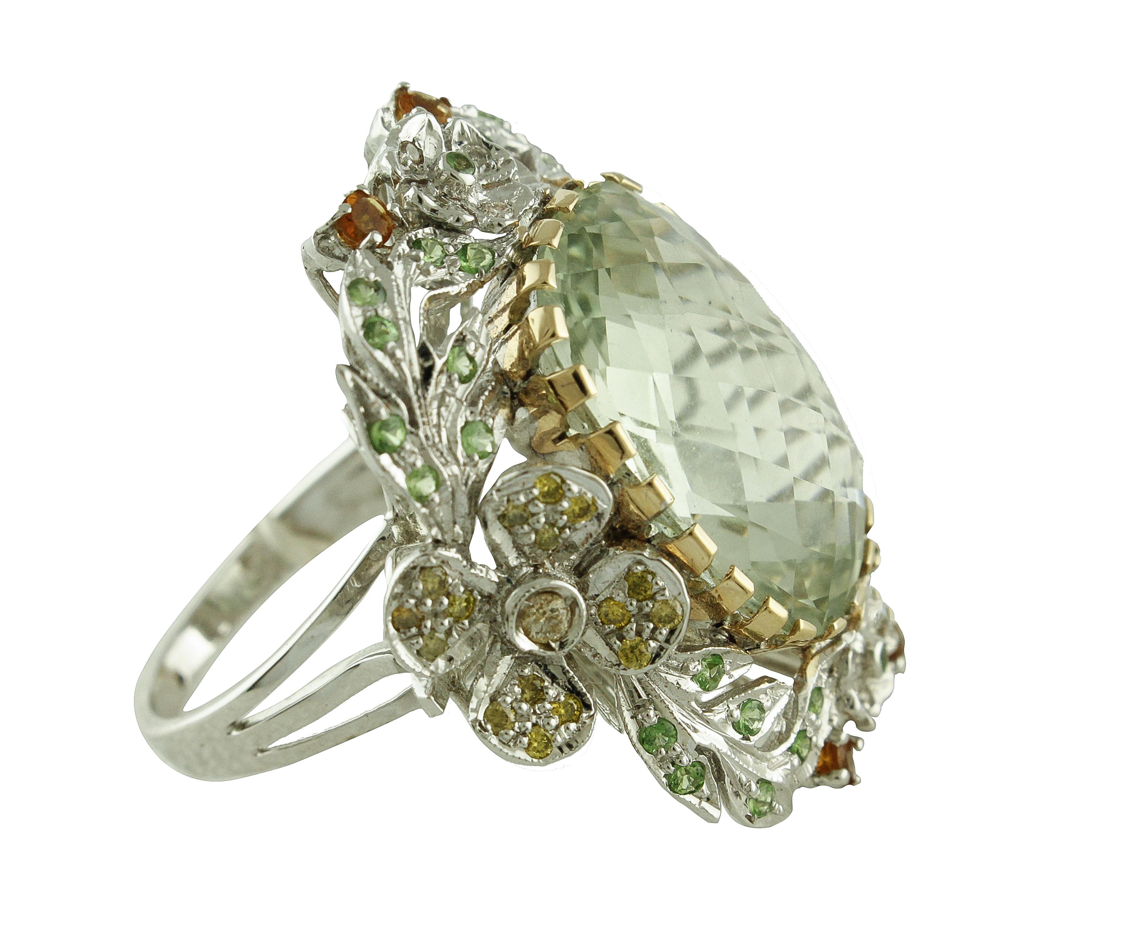 Cluster ring in 14k white and yellow gold mounted with big green amethyst in the center, white and yellow diamonds, topaz, tsavorite all around.
Diamonds 0.55 
Topaz, Tsavorite 0.94 kt 
Green Amethyst 16.18 kt
Tot.Weight 14.80 gr
R.F ffog


For any