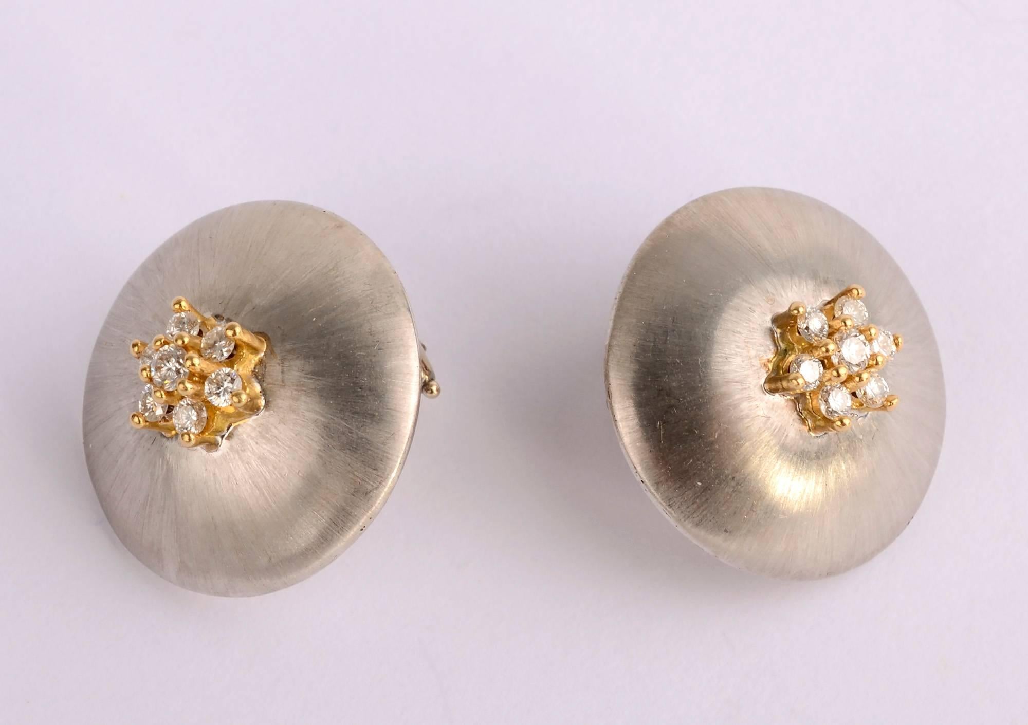 Delicate domed earrings in a slightly brushed white gold with 7 diamonds 
set in yellow gold. They have much of the look of Buccellati without the corresponding price. The front is 18 karat gold with 14 karat clips. The clips can be converted to