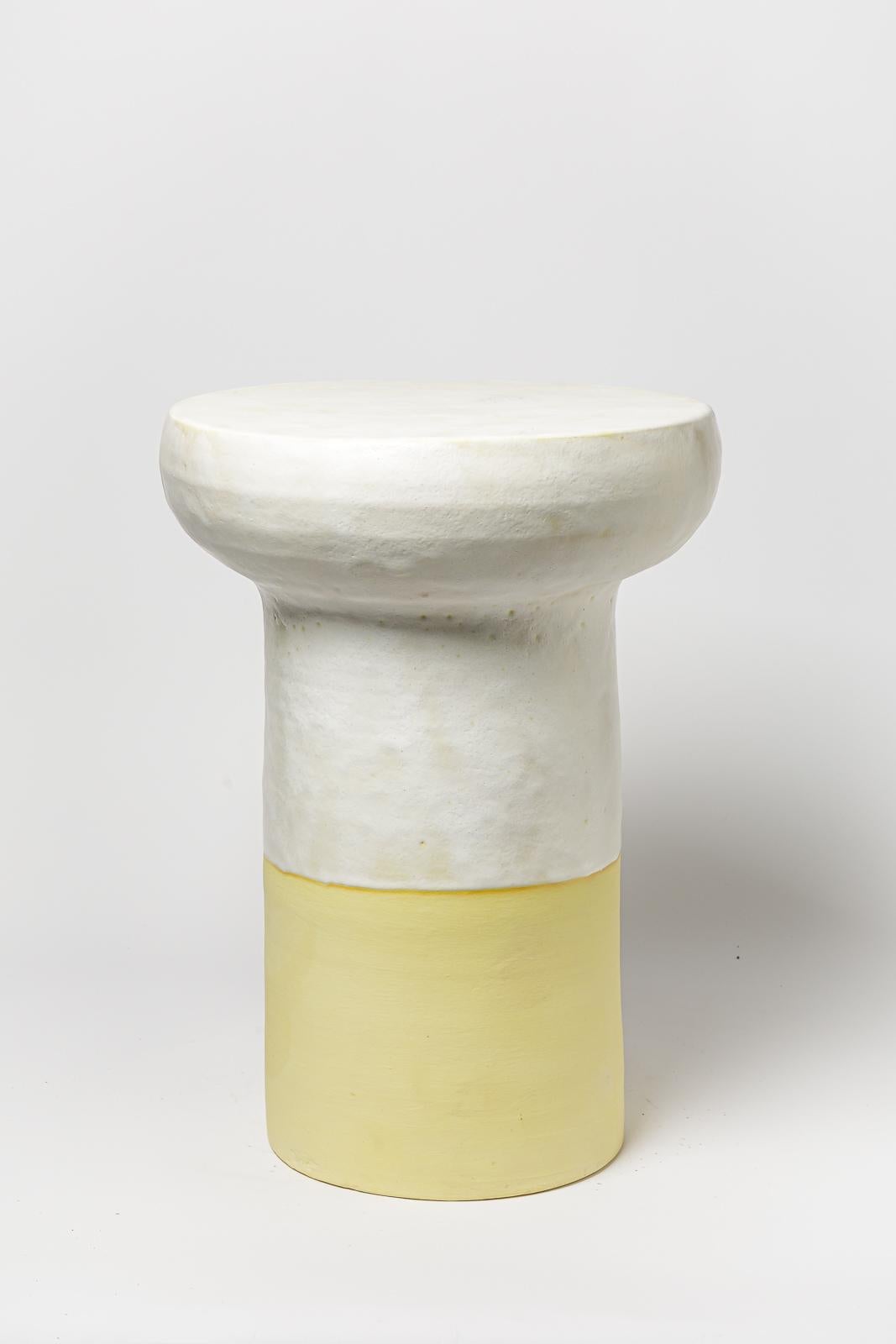 White and yellow glazed ceramic stool or coffee table by Mia Jensen. 
Artist signature under the base. 2023.
H : 21.6’ x 15.3’ inches.