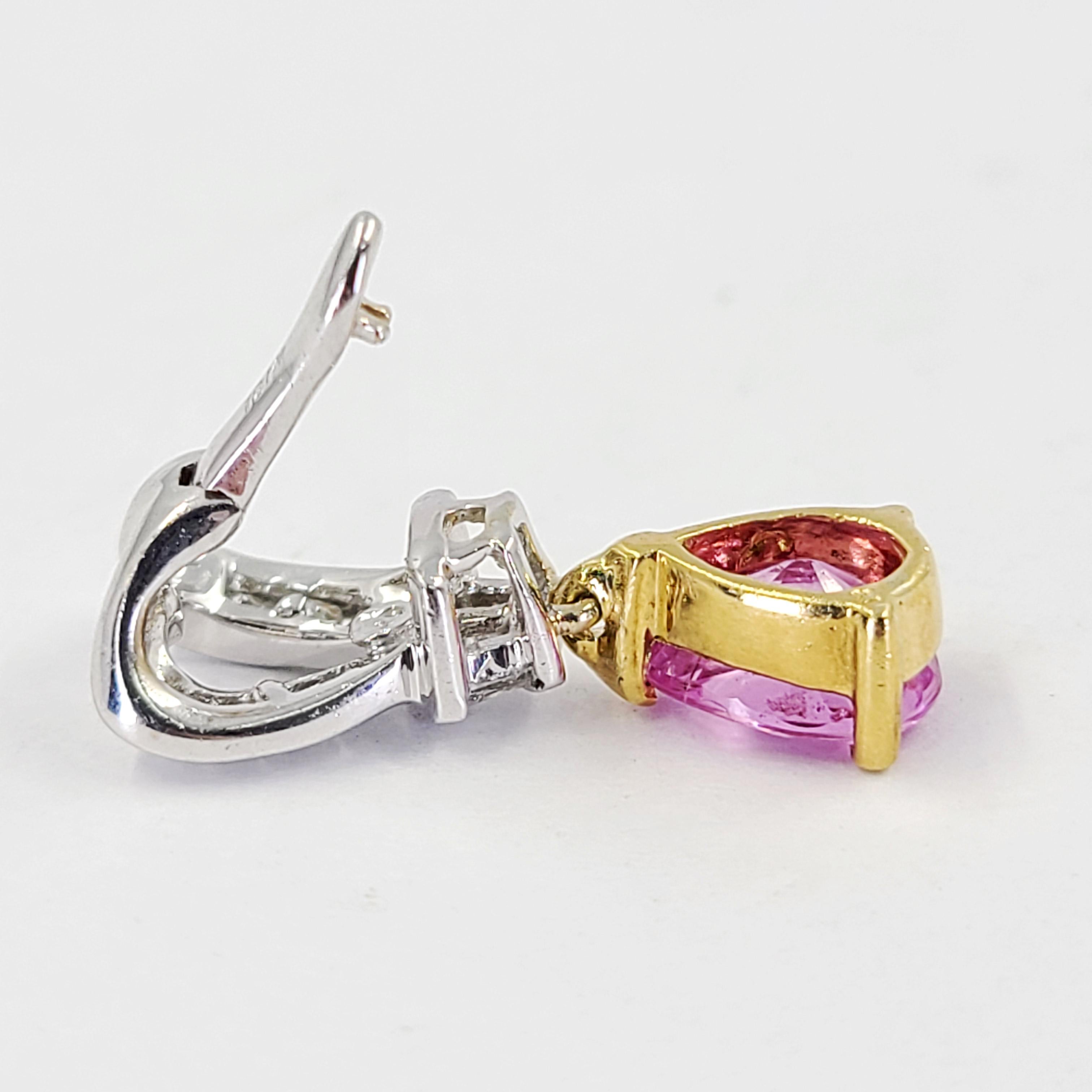 18 Karat White & Yellow Gold Hinged Enhancer Pendant Featuring A Dangling 1 Carat Pear Cut Pink Sapphire Accented By 10 Channel Set Round & Baguette Cut Diamonds Of VS Clarity & H Color Totaling 0.25 Carats. 0.75 Inch Length. Does not include a
