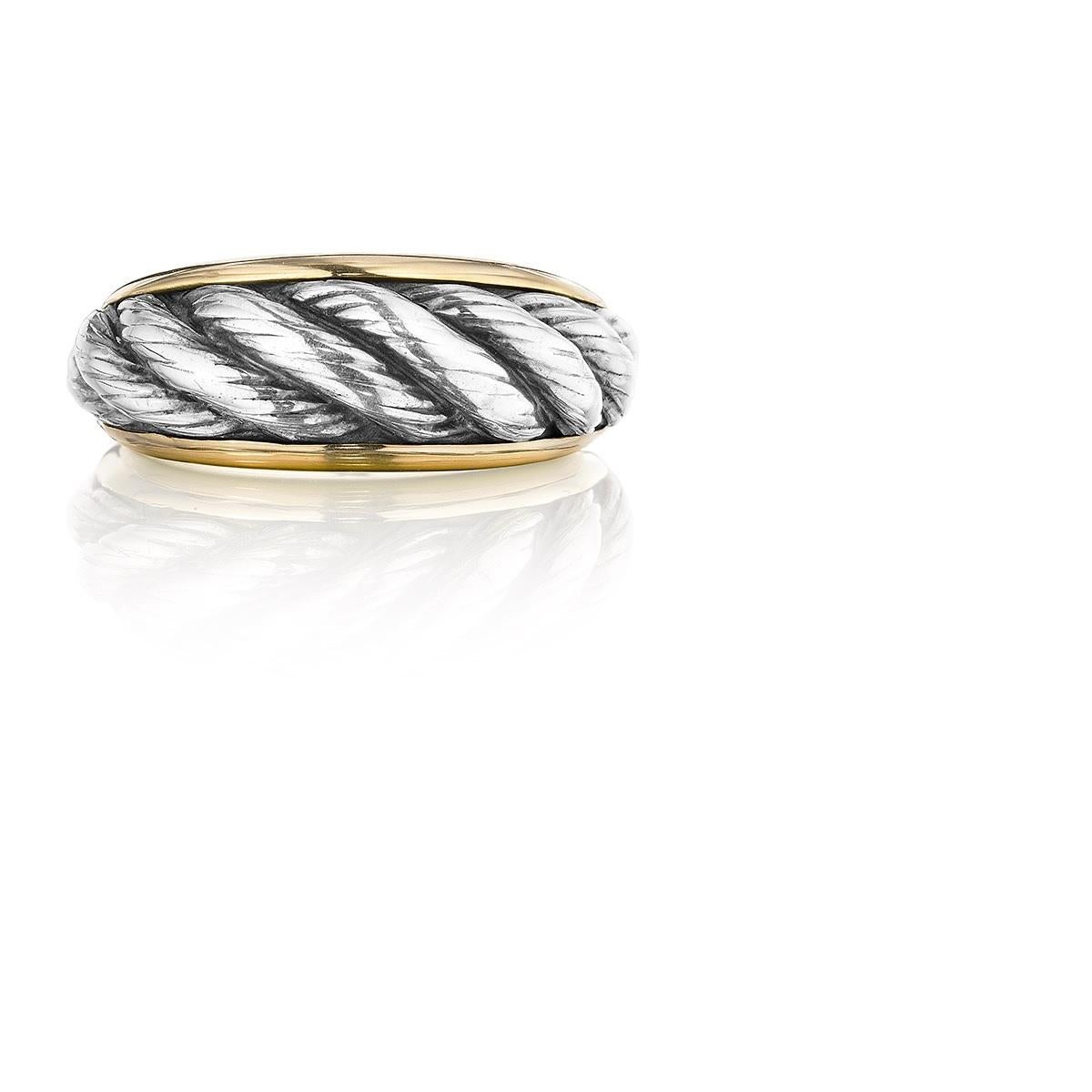 An 18 karat white and yellow gold ring by Van Cleef & Arpels. The center of the ring is white gold with a twisted rope pattern.  Circa 1970's.
Signed, 