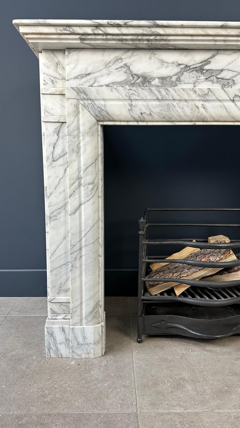 Antique Art Deco Fireplace in beautiful veined white marble. This fireplace comes from a beautiful mansion in the center of Amsterdam just behind the municipal museum. The fireplace has a modest but luxurious stylish appearance. Because this is a