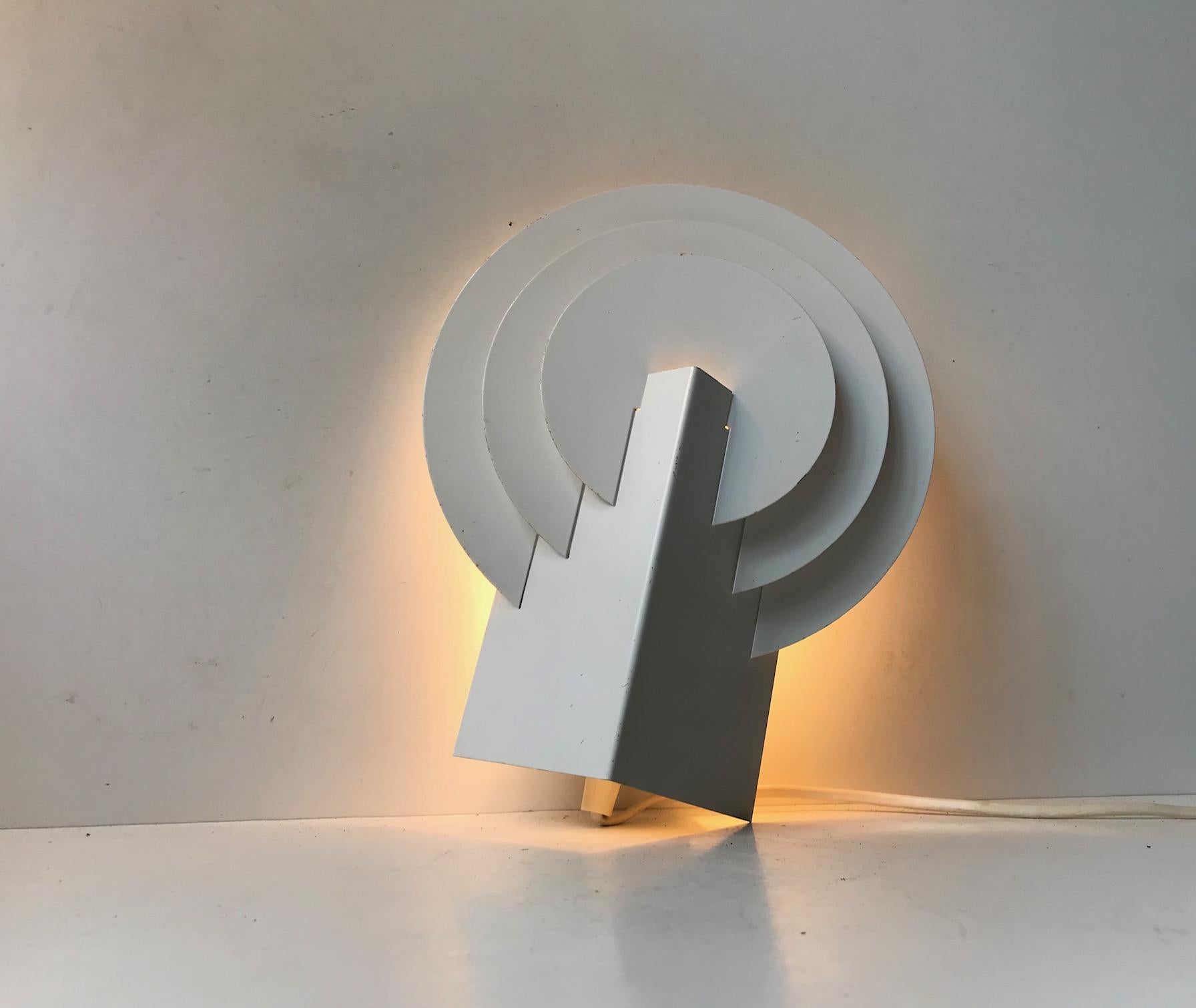 A white powder coated steel wall light designed and manufactured by Lyskær in Denmark during the 1970s or 1980s. Reminiscent of Bent Karlby's Peacock.