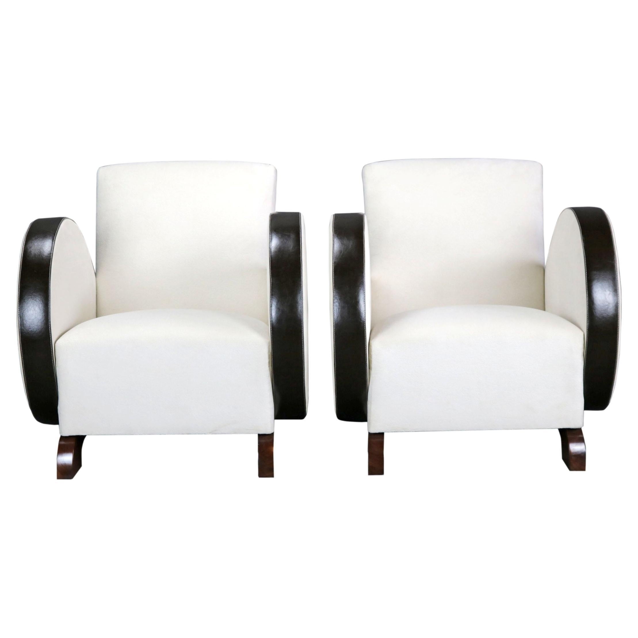 A pair of beautiful and stylish white Art Deco armchairs, with a streamlioned and dynamic design. The upholstery is from a comfortable and elegand fabric. The arms are covered with genuine natural leather - this provides a protection against wear.