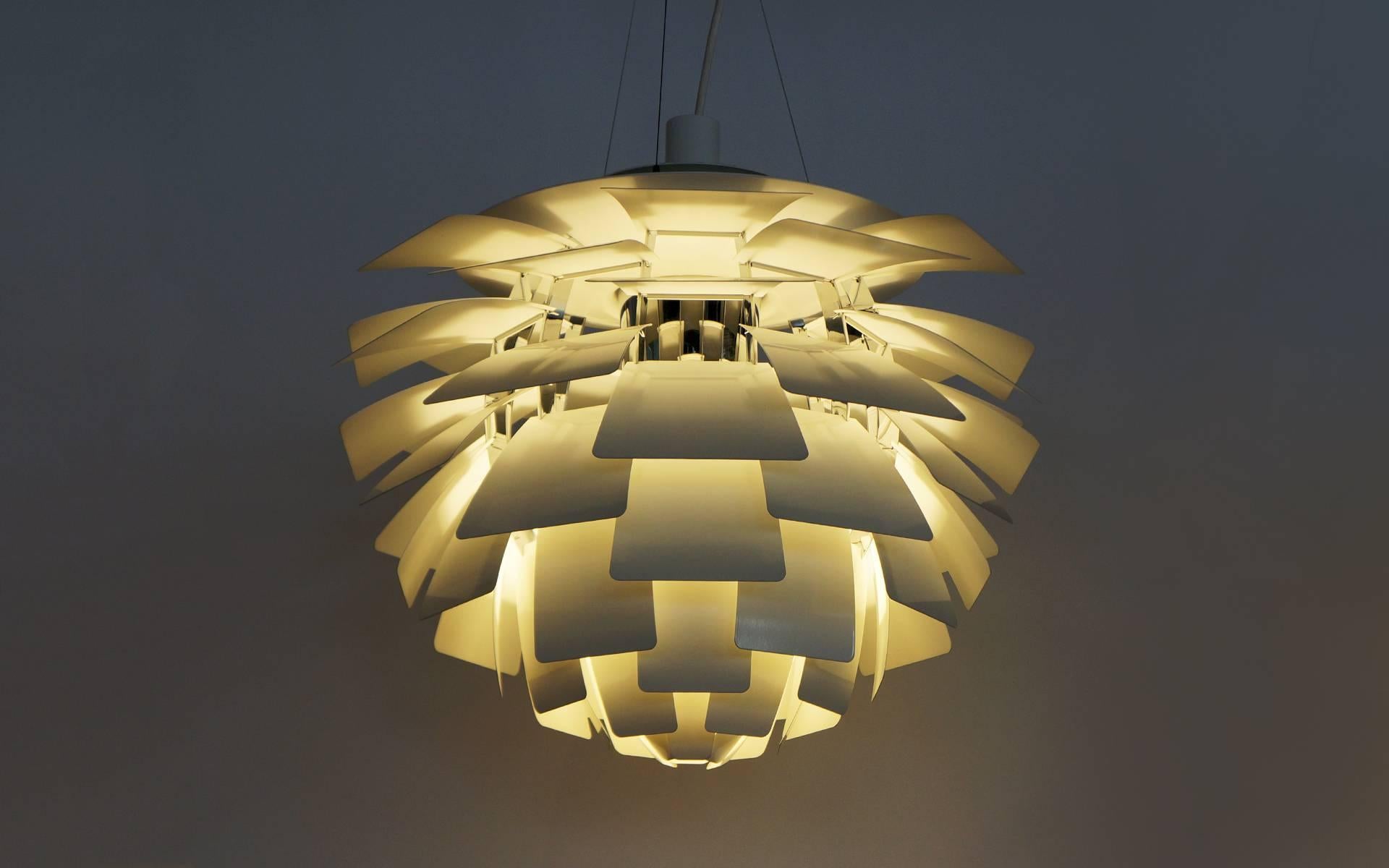 This is an authentic recent production Artichoke chandelier / light fixture designed by Poul Henningsen and made by Louis Poulsen, Denmark. The best price to buy this new is $15000. Our price is $9500 and it is just like new. 23.6 inch diameter.