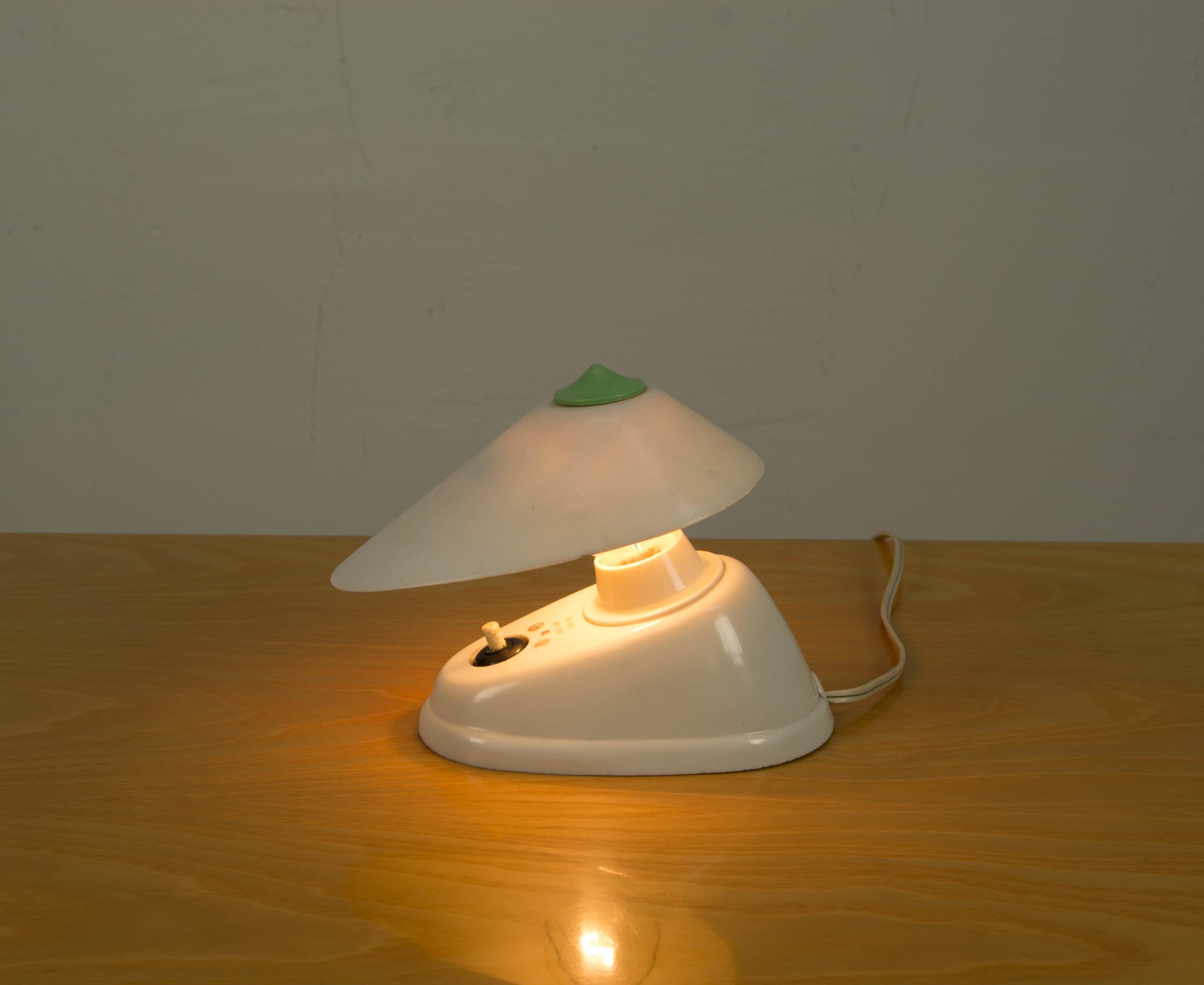 Small bakelite table or wall lamp with adjustable shade. Good original condition.