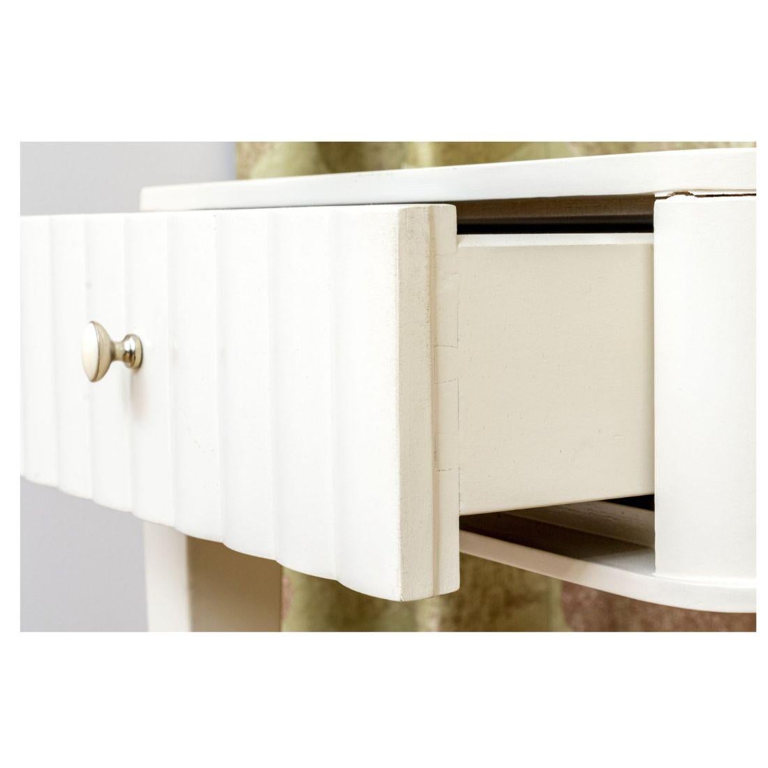 A super chic white writing desk attributed to Barbara Barry for Henredon.  With a carved and fluted front encasing two drawers and two larger drawers on either side with nickel drawer pulls, the desk is both beautiful and functional.  The desk sits