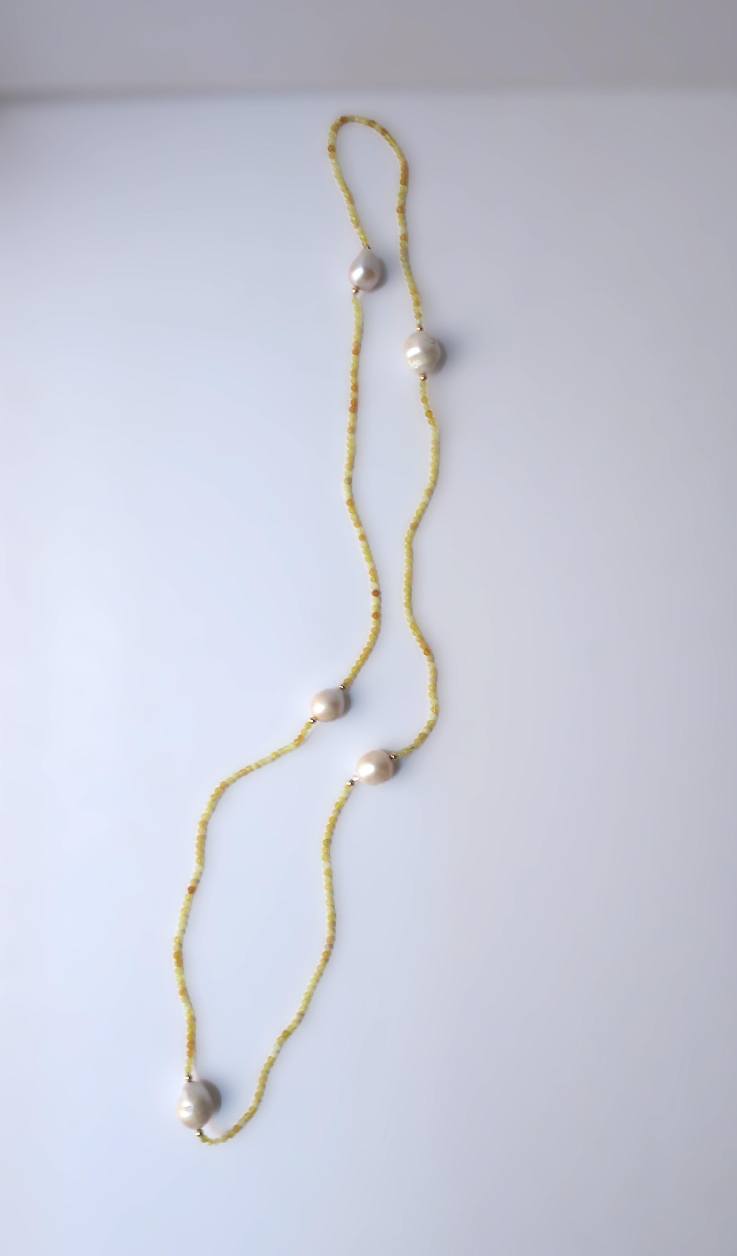 A beautiful long necklace of real, relatively large, 5 white freshwater baroque pearls, 14-karat gold beads, and yellow tumbled stone beads. 

Dimensions: 34.5