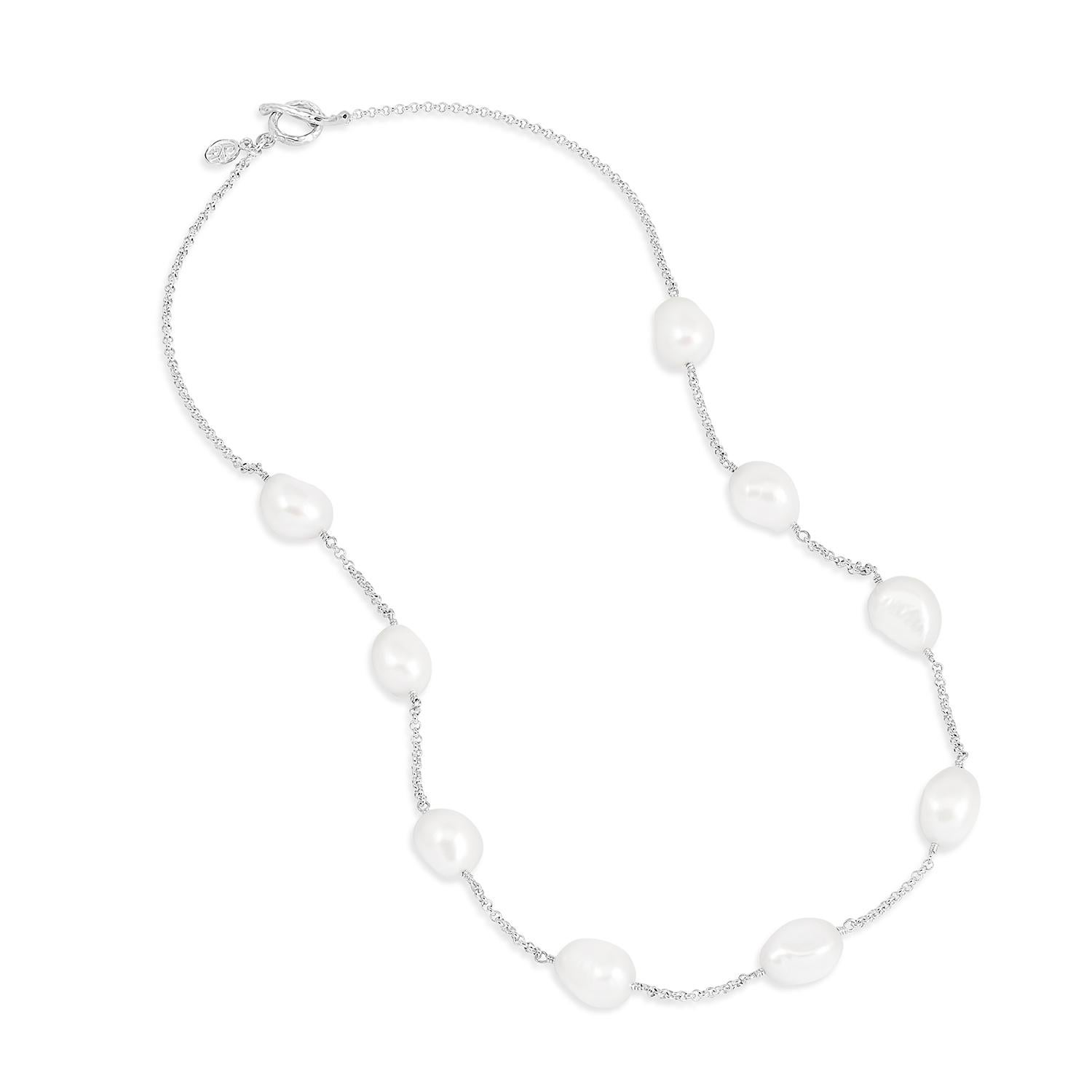 Made in our London studio, this sterling silver necklace features large, lustrous white baroque freshwater pearls suspended on fine chain. The necklace is finished with our signature contemporary hammered loop and t-bar clasp. 

Pearl sizes -